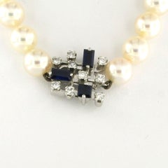 14k gold lock with sapphire and brilliant cut diamonds with pearl necklace