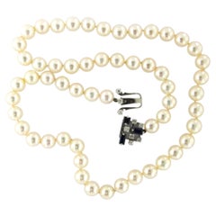 14k gold lock with sapphire and brilliant cut diamonds with pearl necklace