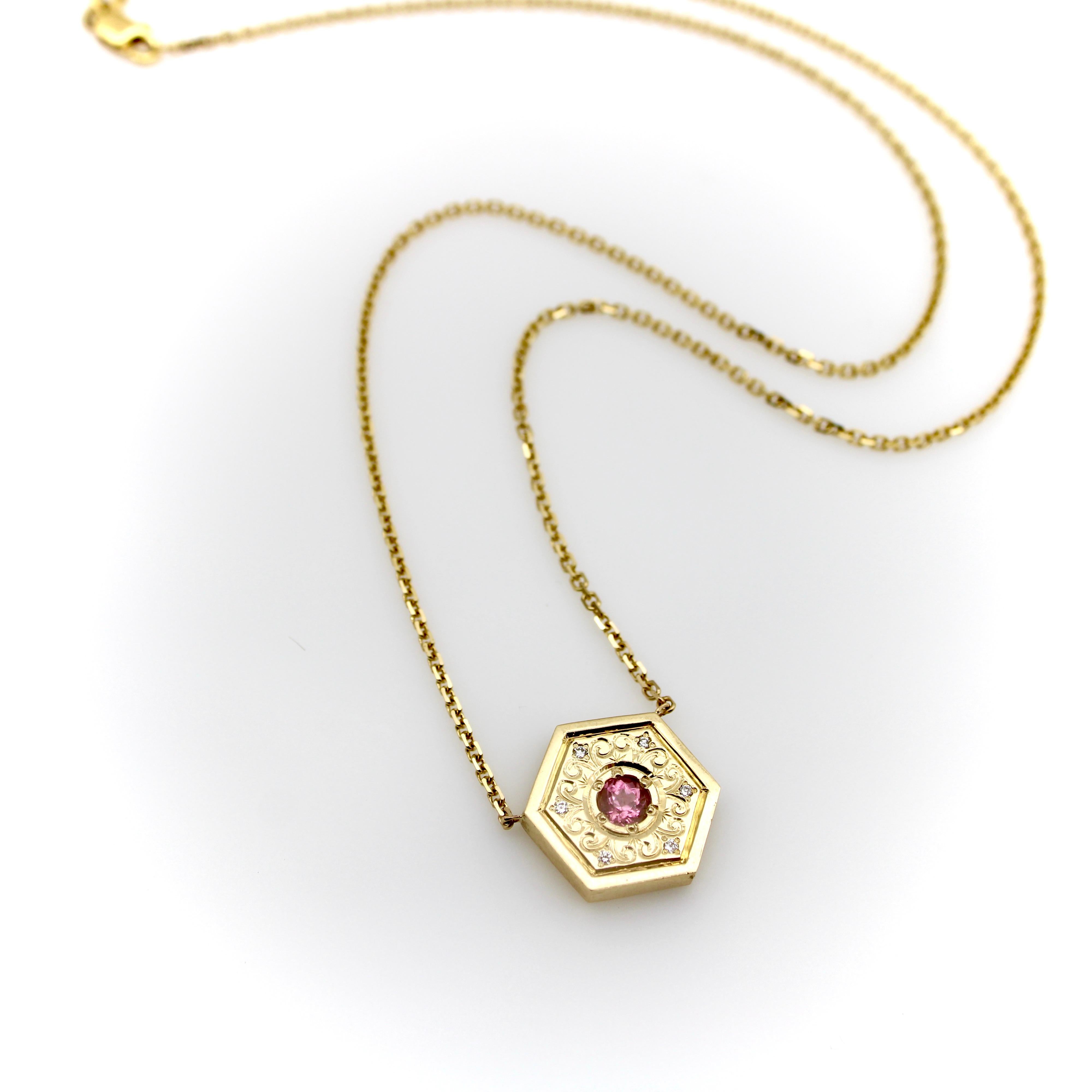 This 14k gold mandala medallion is a one-of-a-kind piece of jewelry, perfect for a yoga or meditation lover. It is hand-engraved with a rhythmic motif of scrolling foliage surrounding a sparkling pink tourmaline. Tiny single cut diamonds are