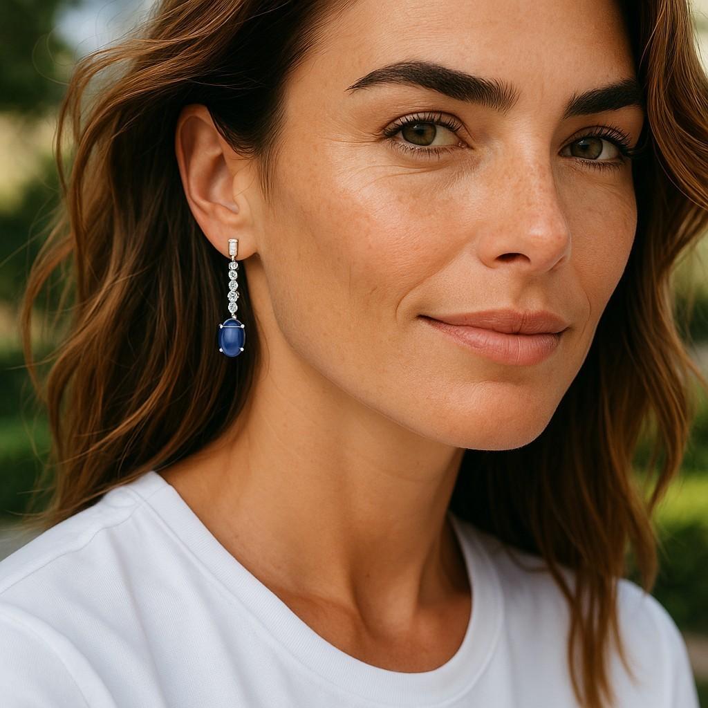 Elevate your elegance with this stunning pair of 14K white gold earrings featuring a matched pair of exquisite Ceylon Cabochon Sapphires. Weighing a total of 6.66 carats, these sapphires showcase a mesmerizing medium sky blue hue with fine crystal