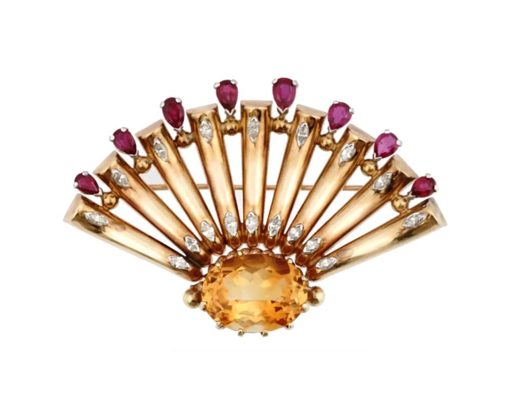 A retro M. C. Mossalone 14K Yellow Gold figural brooch. The brooch is made in a shape of a fan with an openwork design. The ware is encrusted with 17.8 cts Citrine stone, pear cut Ruby stones and Diamonds. Marked with a standard Gold hallmark, and a