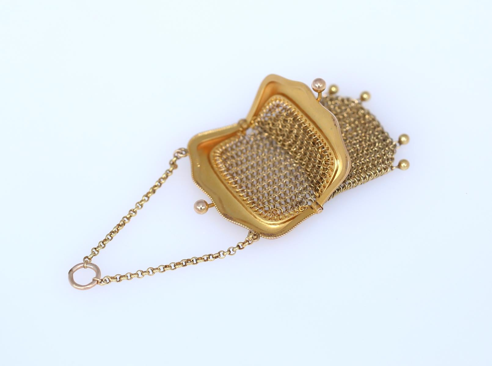 14K Gold Mesh Purse Chain, Created around 1895. 
14K Yellow Gold Mesh purse on a small chain representing a fine trend in Europe at the beginning of the 20th century, to actually use such a fine purse as pockets hanging down from the waist. A truly