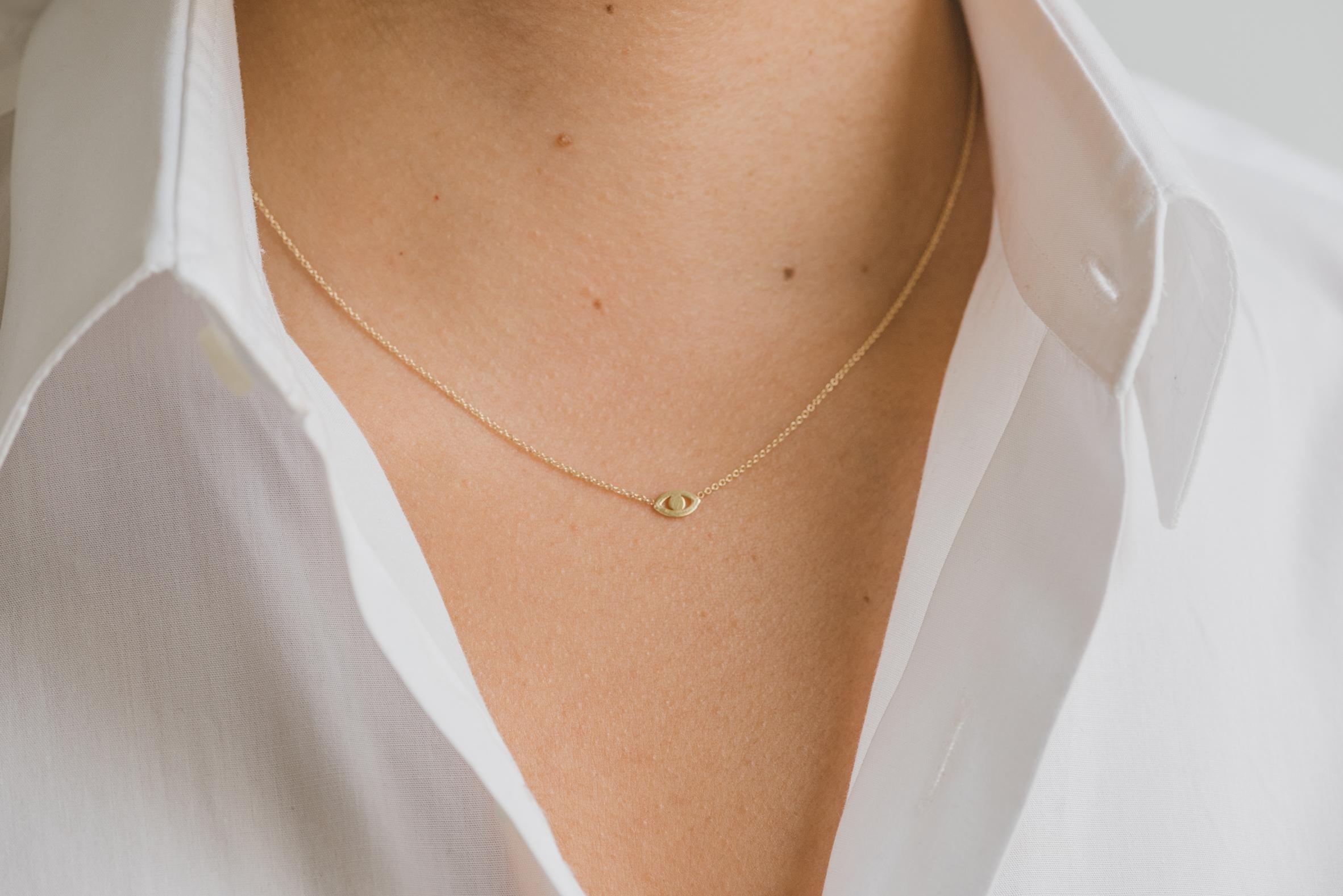 14k solid gold mini evil eye necklace, a dainty and classic must have! Effortlessly chic, perfect by itself or layered, available in 14k yellow gold, with a 16''-18'' adjustable chain.

Size: Approx. 6mm by 4mm
Weight : Approx. 1.1 Grams

Comes gift