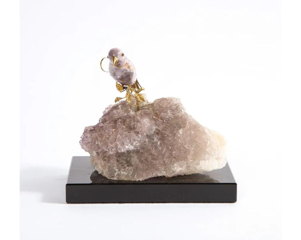 A 14K Gold Mounted Agate Bird on Fluorite Stone, Mounted on Black Glass, 20th century.

A really nice and cool object - a true collectors piece. Part of a group of five birds, please see our other listings for the rest of this