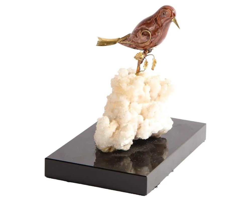 A 14K gold mounted Jasper bird on white calcite stone, mounted on black glass, 20th century.

A really nice and cool object - a true collectors piece. Part of a group of five birds, please see our other listings for the rest of this