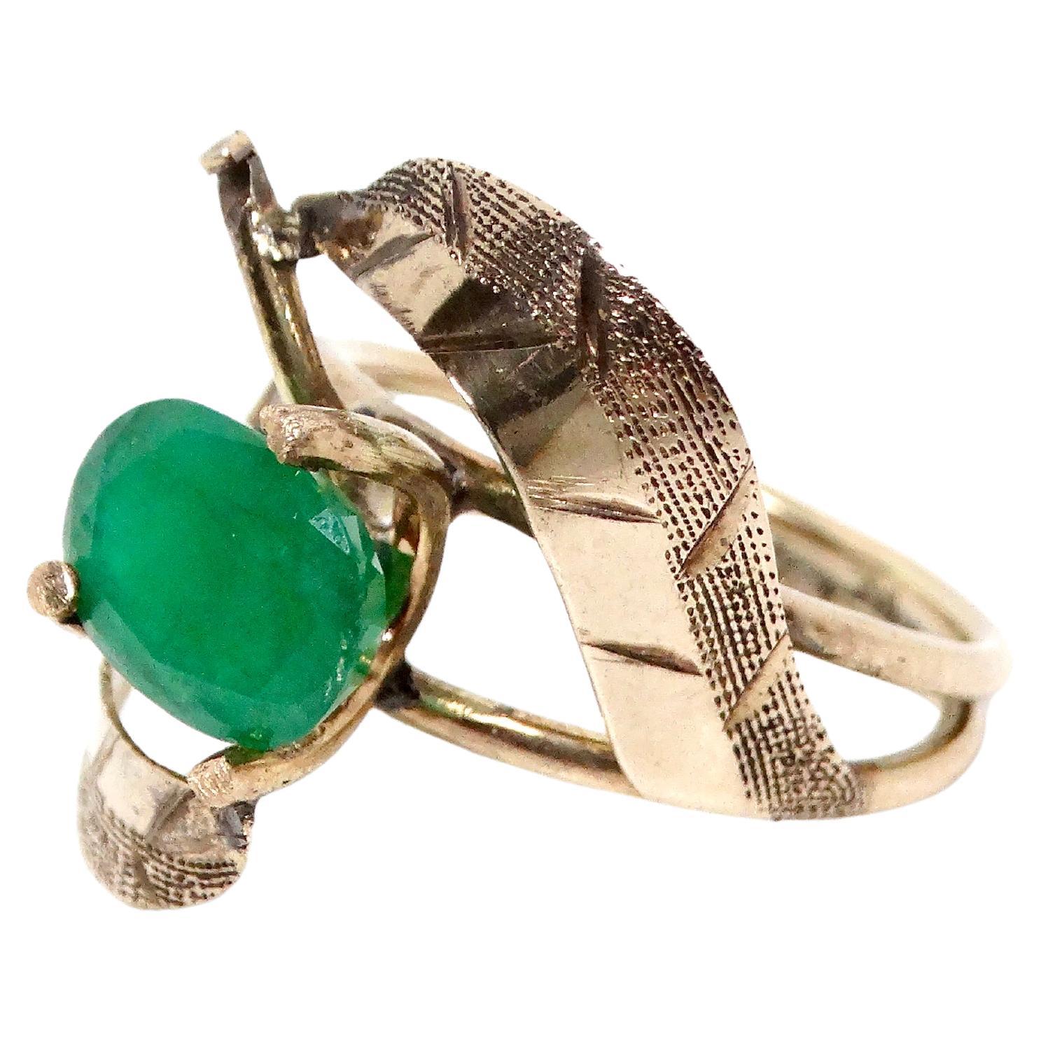 This stunning 14k gold natural emerald cocktail ring from the 1960s epitomizes vintage elegance and timeless sophistication. Featuring a vibrant, approximately 2-carat genuine emerald, the ring’s rich green hue radiates a captivating allure that