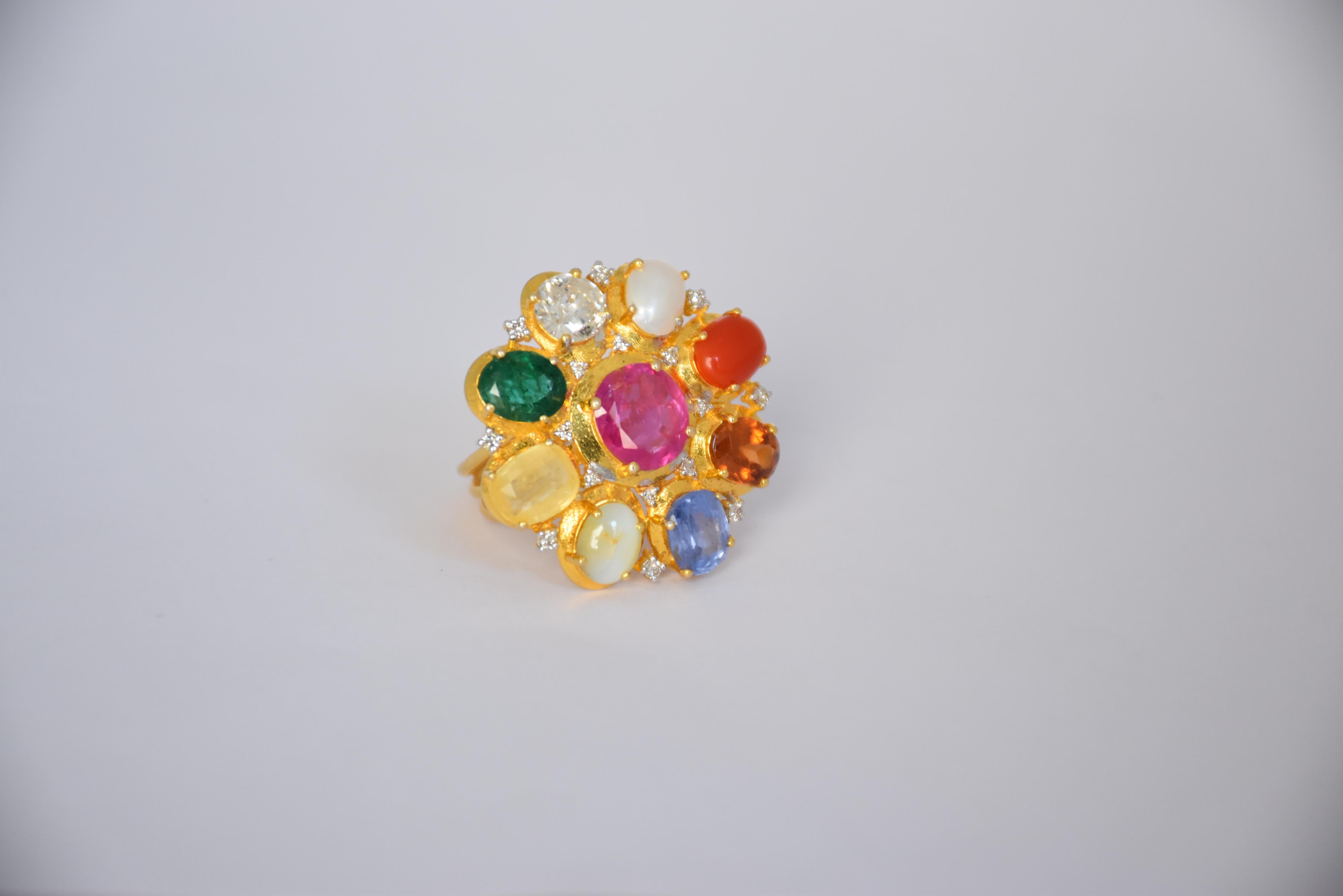 This stunning 14K gold Navratna ring is our effort to bring a new facet of modernism to traditional Indian designs. This ring contains a center flower beholding all nine precious natural gemstones which include Ruby, Yellow Sapphire, Rose Cut