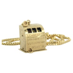 Halskette aus 14k Gold mit einem Anhänger in Form einer Schlitzmaschine - 16,8 Gramm - 50 cm lang