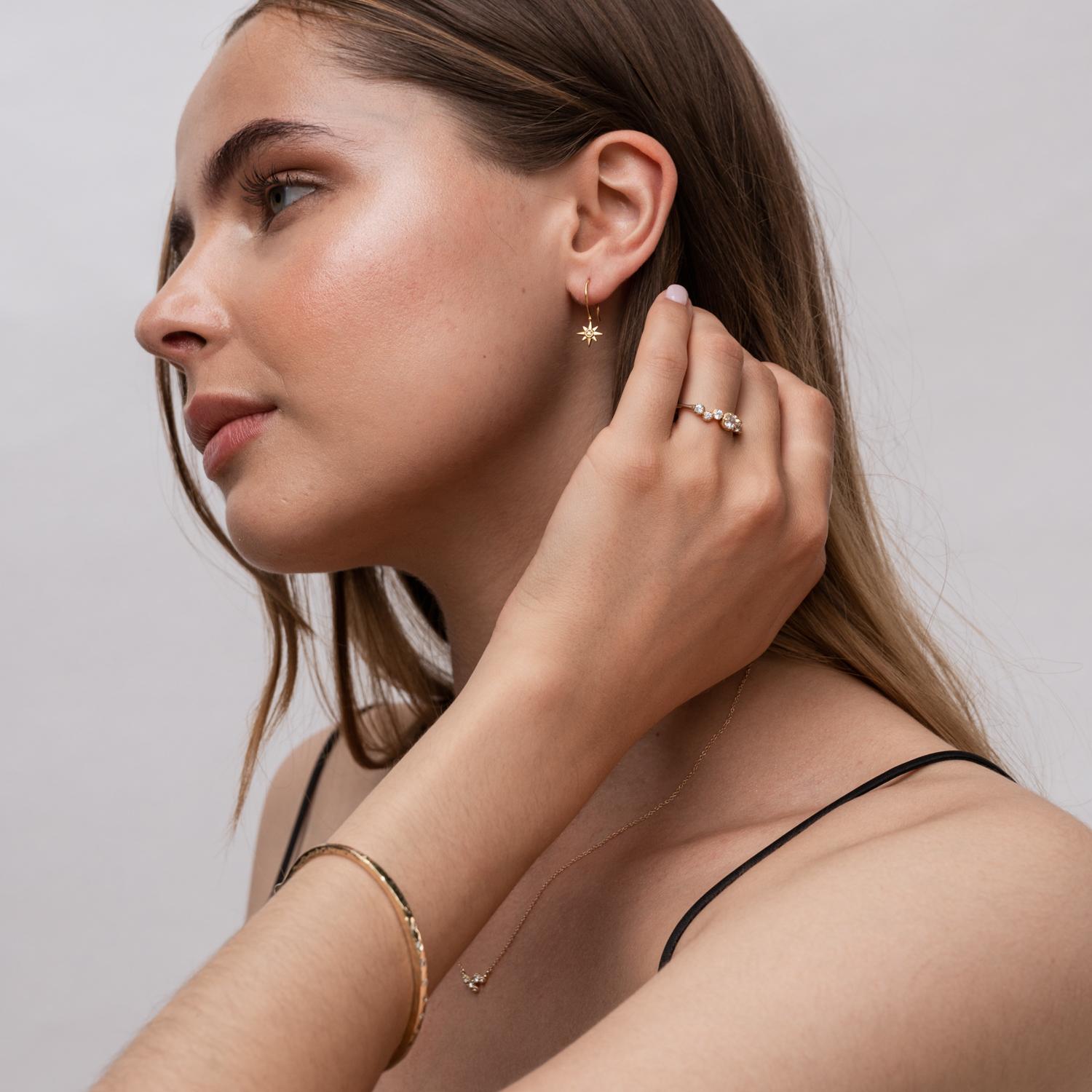Our fine North Star range is a new collection of 14k Gold and Diamond guiding stars inspired by our ever-popular 'True North' Talisman designs.

Delicate eight pointed North Star ear-drops claw set with diamonds and hung on fine wires. These