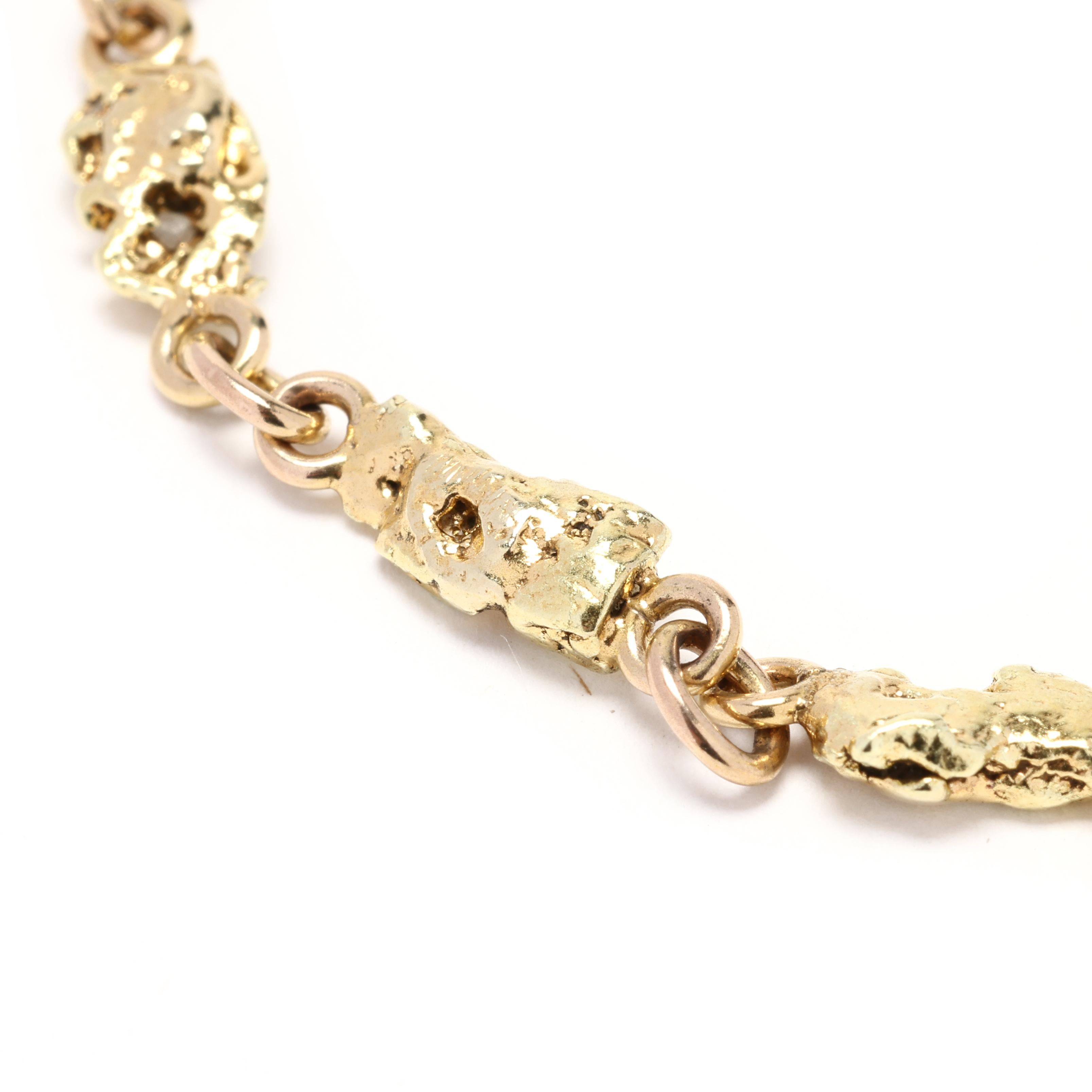 Elevate your style with this exquisite 14k Gold Nugget Bracelet. Featuring genuine gold nuggets elegantly set on an 18k yellow gold chain, this bracelet exudes luxury and sophistication. With its versatile design and perfect length of 7.13 inches,