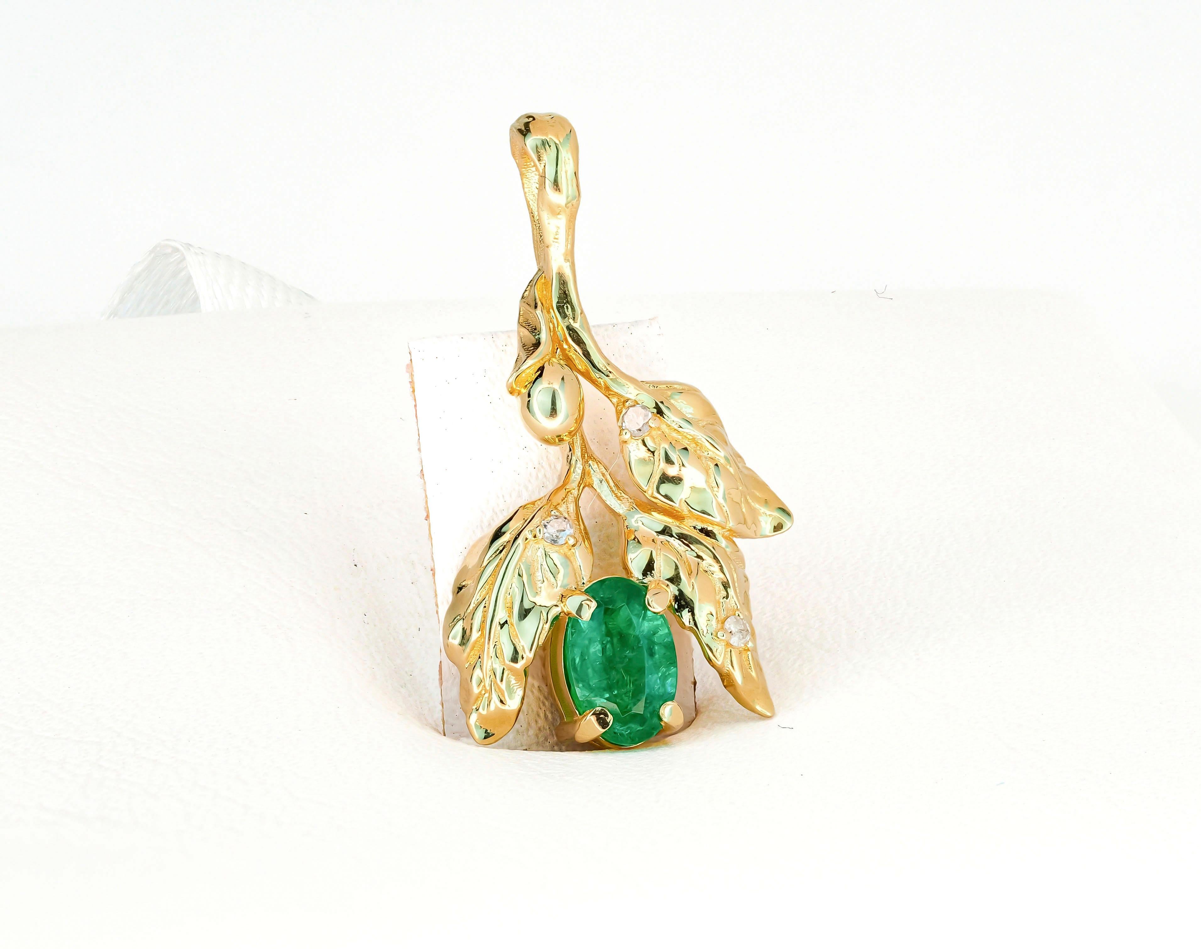 14k  gold olive pendant with natural emerald and diamonds. 
May birthstone.
Metal: 14kt solid gold
Pendant size: 23.3 x1 3.7 mm.
Weight: 2.4 g.

Gemstones:
Natural emeralds: 1 piece, weight - approx 0.70 ct.
Oval cut, green color,