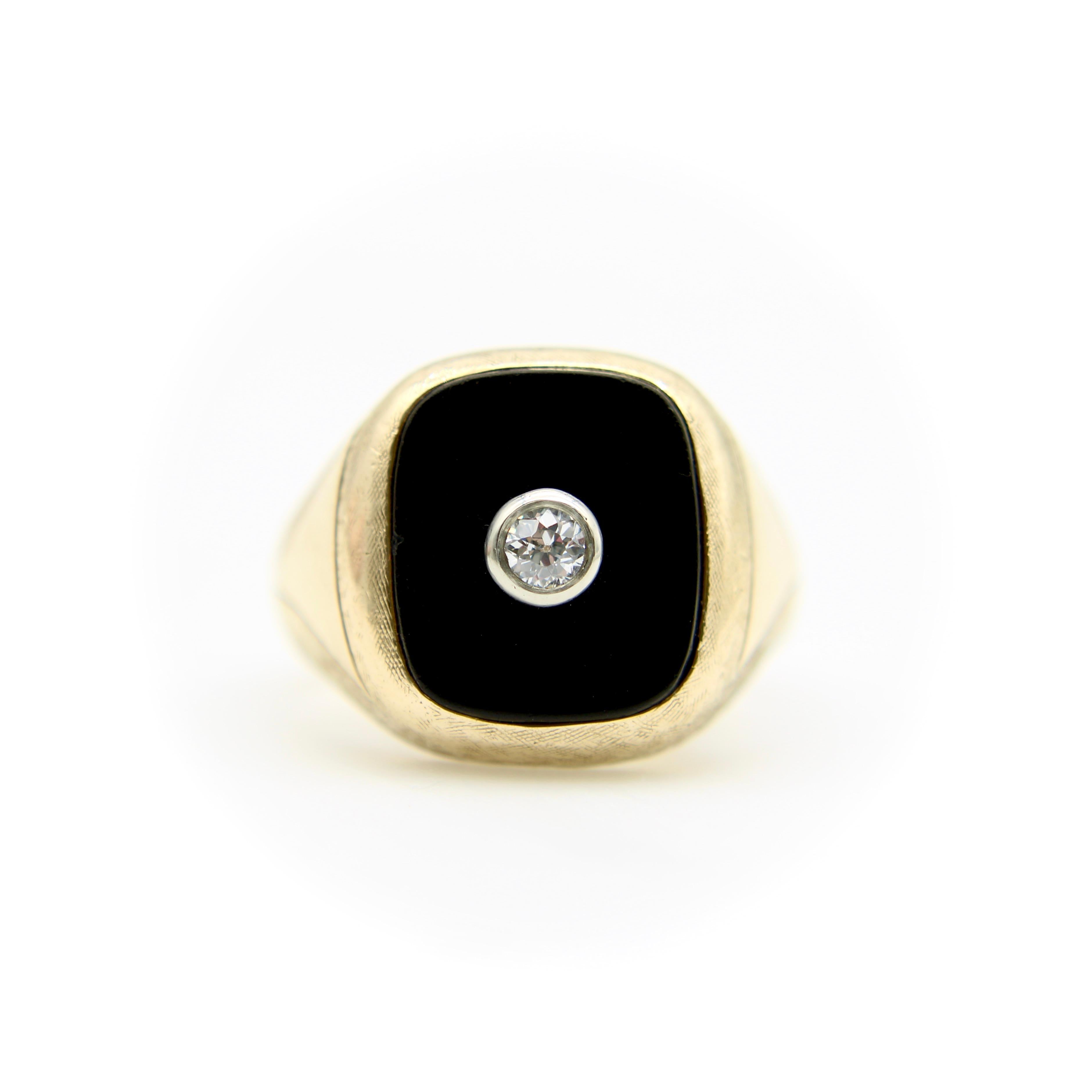 This is a classic Art Deco men’s ring, circa the 1920’s. The 14k gold ring features a rectangular onyx panel with rounded corners. In its center is an Old European Cut diamond, bezel set in platinum. The gold has a beautiful Florentine finish that