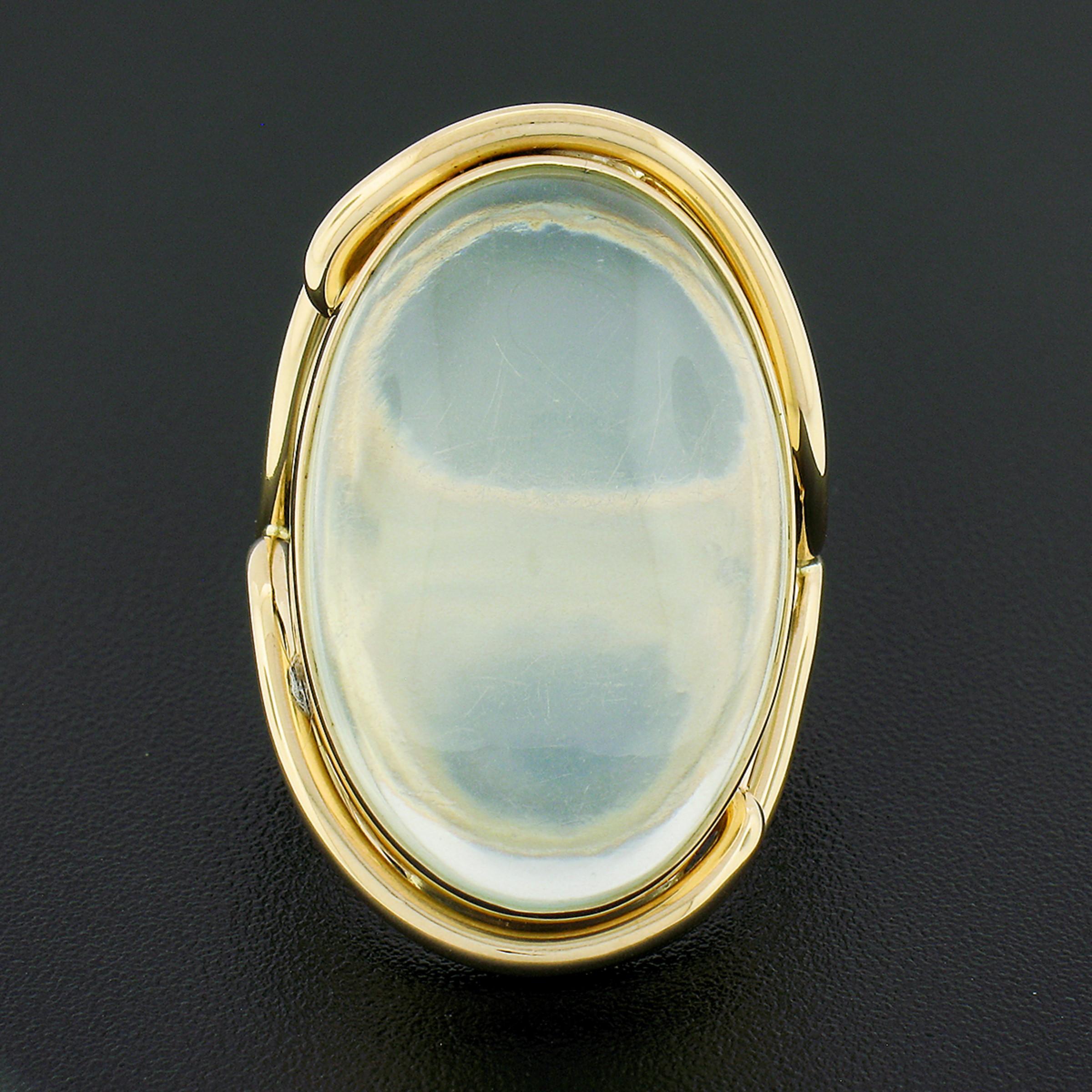 Here we have a truly bold and very well made ring crafted in solid 14k yellow gold and features a large, GIA certified, oval cabochon cut moonstone neatly bezel set at the center. The solitaire has a truly gorgeous and clean transparent light yellow