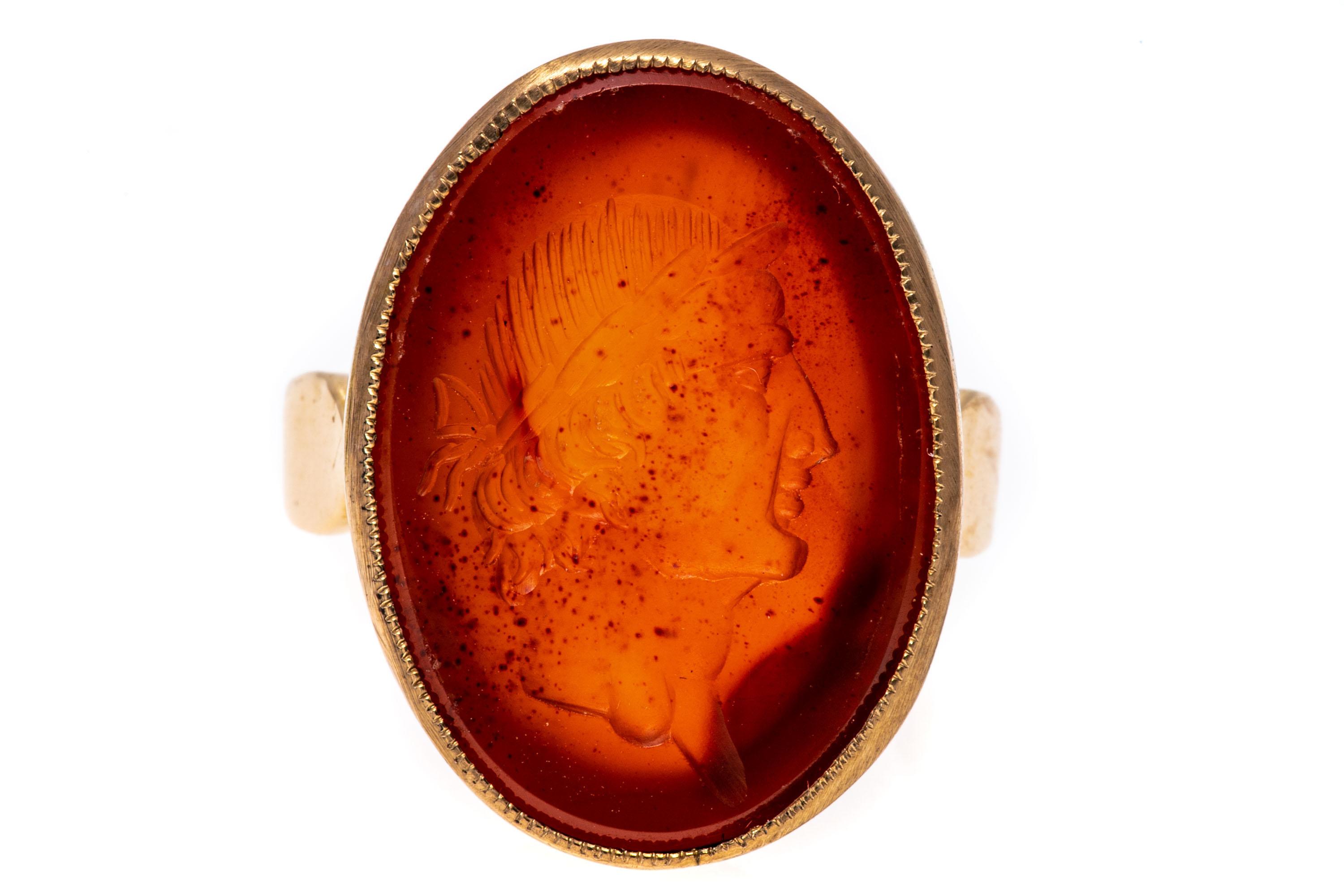 14k gold ring. This attractive oval carnelian intaglio ring features a handsome figure of a Greco-Roman soldier, facing to the right and set with off by simple shoulders.
Marks: None, tests 14k
Dimensions: 9/16