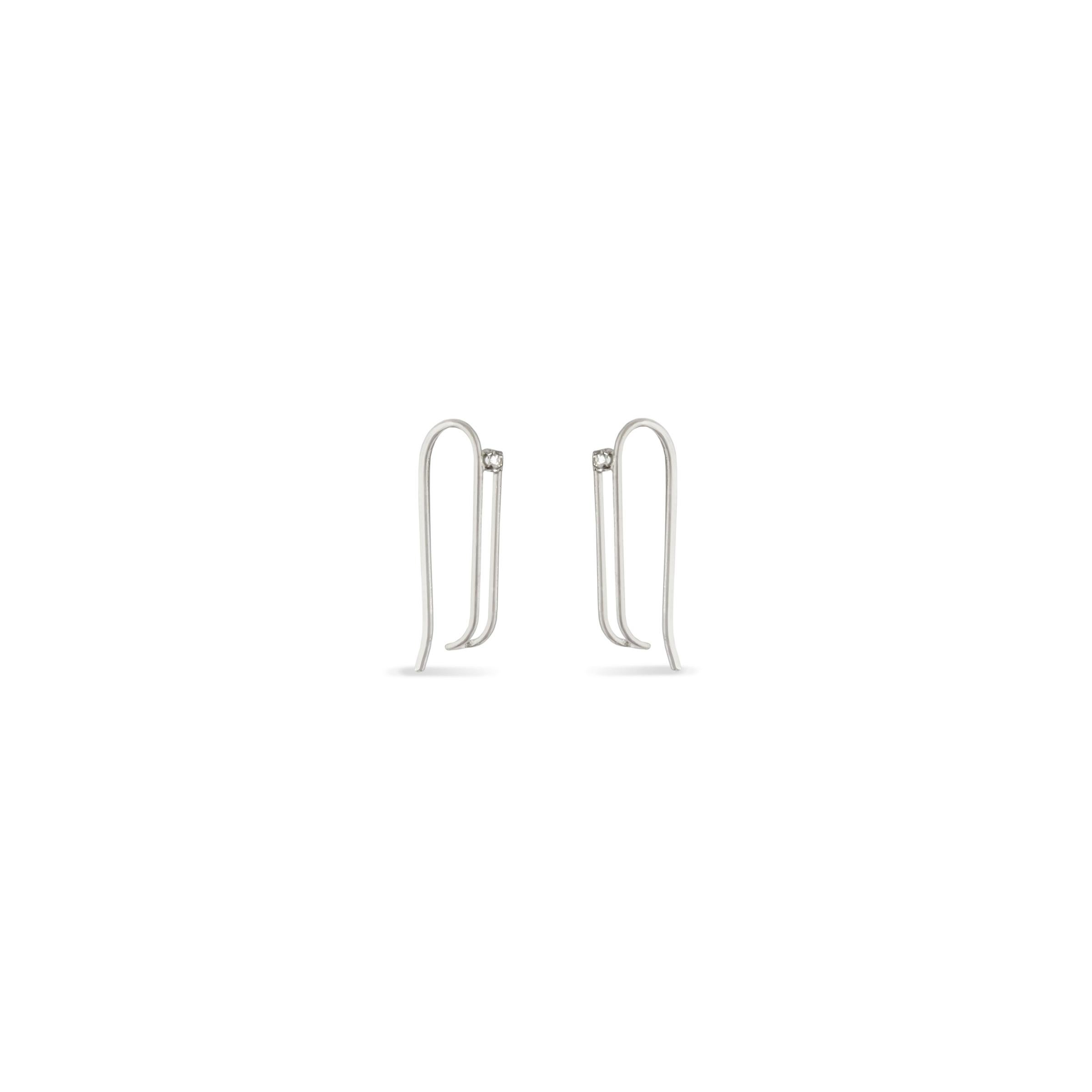 Paperclip-style hoop earrings featuring soft curves accented with a 2mm lab-created White Moissanite Gemstone to add a hint of sparkle. The hoops are hand fabricated in recycled 14K gold wire, easy to wear alone or layer with your favorite earring