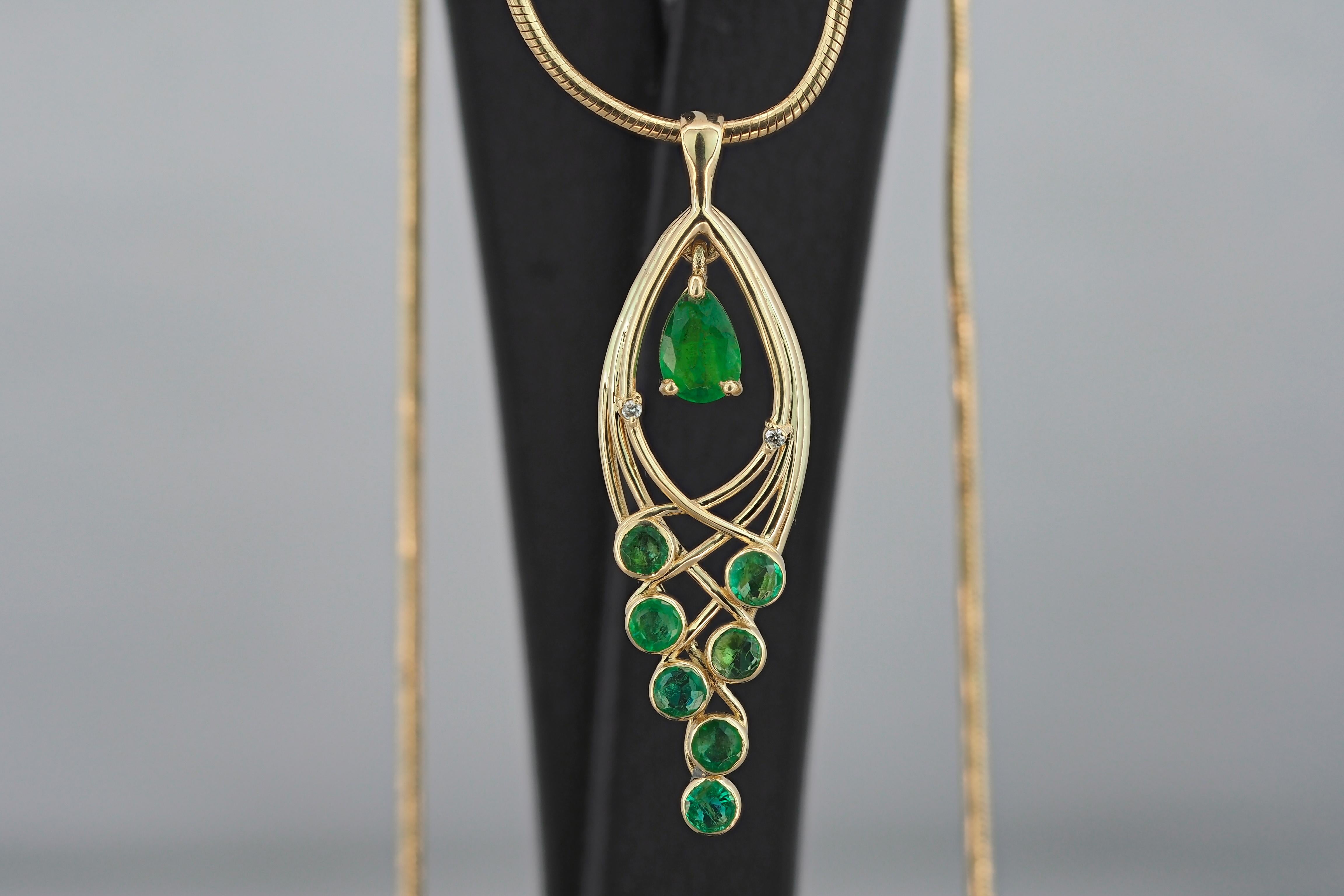 14kt solid gold pendant with natural emerald, emeralds and diamonds.
Weight: 1.4 g.
Pendant size: 35 х 10.33 mm. 
Central stone: Natural emerald
Cut: Pear
Weight: approx 0.70 ct.
Color: Green
Clarity: Transparent with inclusions (See in