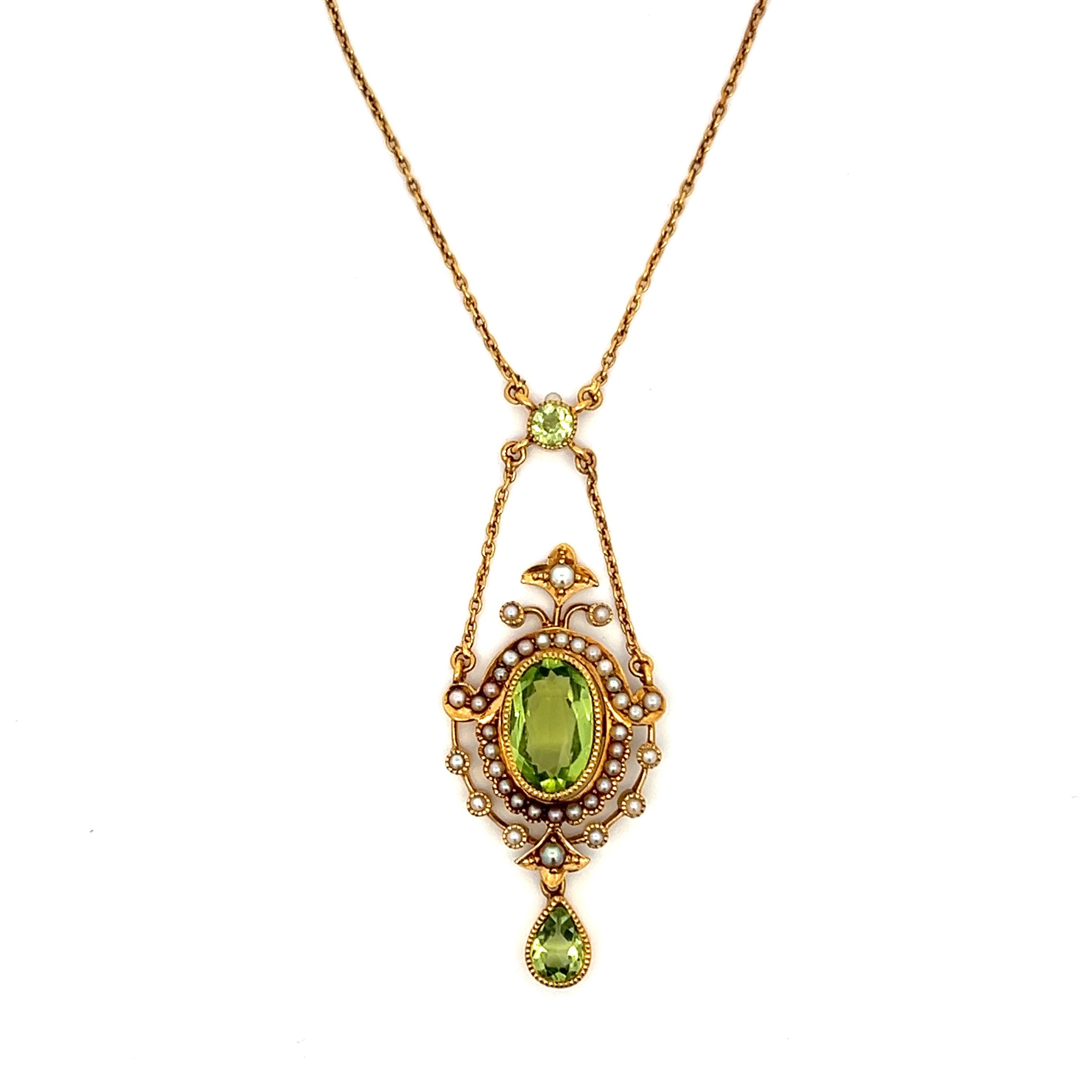 
One Edwardian 14 karat yellow gold pendant set with one 12.5x9mm oval peridot, one 8x5.5 pear shaped peridot, one 4mm round peridot, and thirty-eight small seed ½ pearls. The pendant is suspended on a 14 karat yellow gold 15