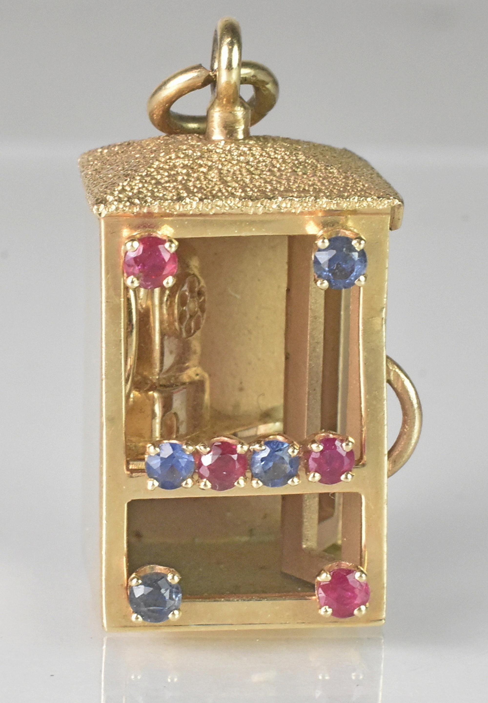 14K gold phonebooth Charm pendant with gems by Dankner. Beautiful blue and red gems on a phonebooth with movable doors. 14K Yellow Gold. Stamped 14K Dankner copyright '53. Great condition wear is consistent with usage and age. 15.9 grams.