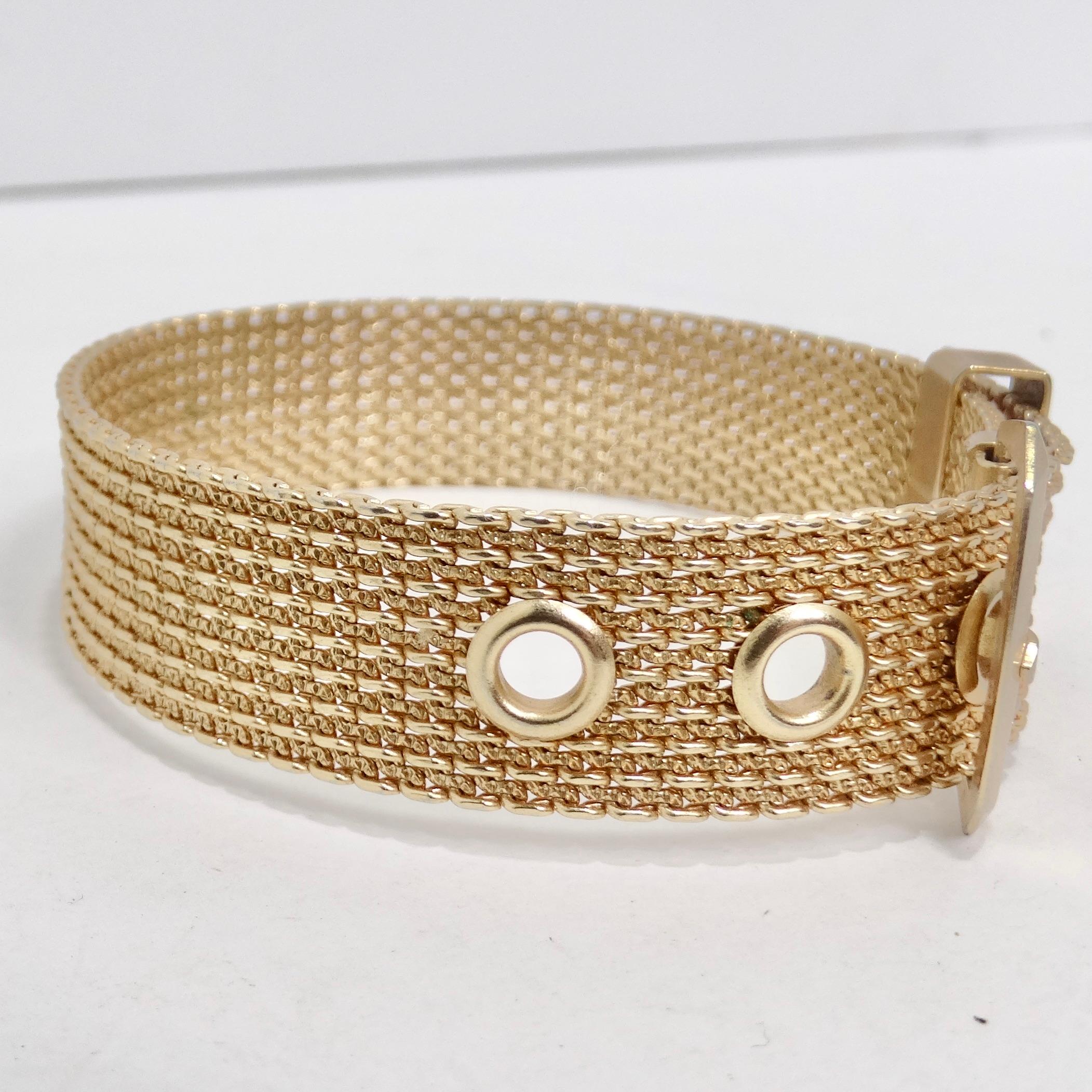 Introducing the 14K Gold Plated Belt Bracelet, a timeless piece that effortlessly combines classic design with modern versatility. Crafted in the 1980s, this exquisite bracelet features a belt buckle motif and a mesh-effect 14K gold plating, making