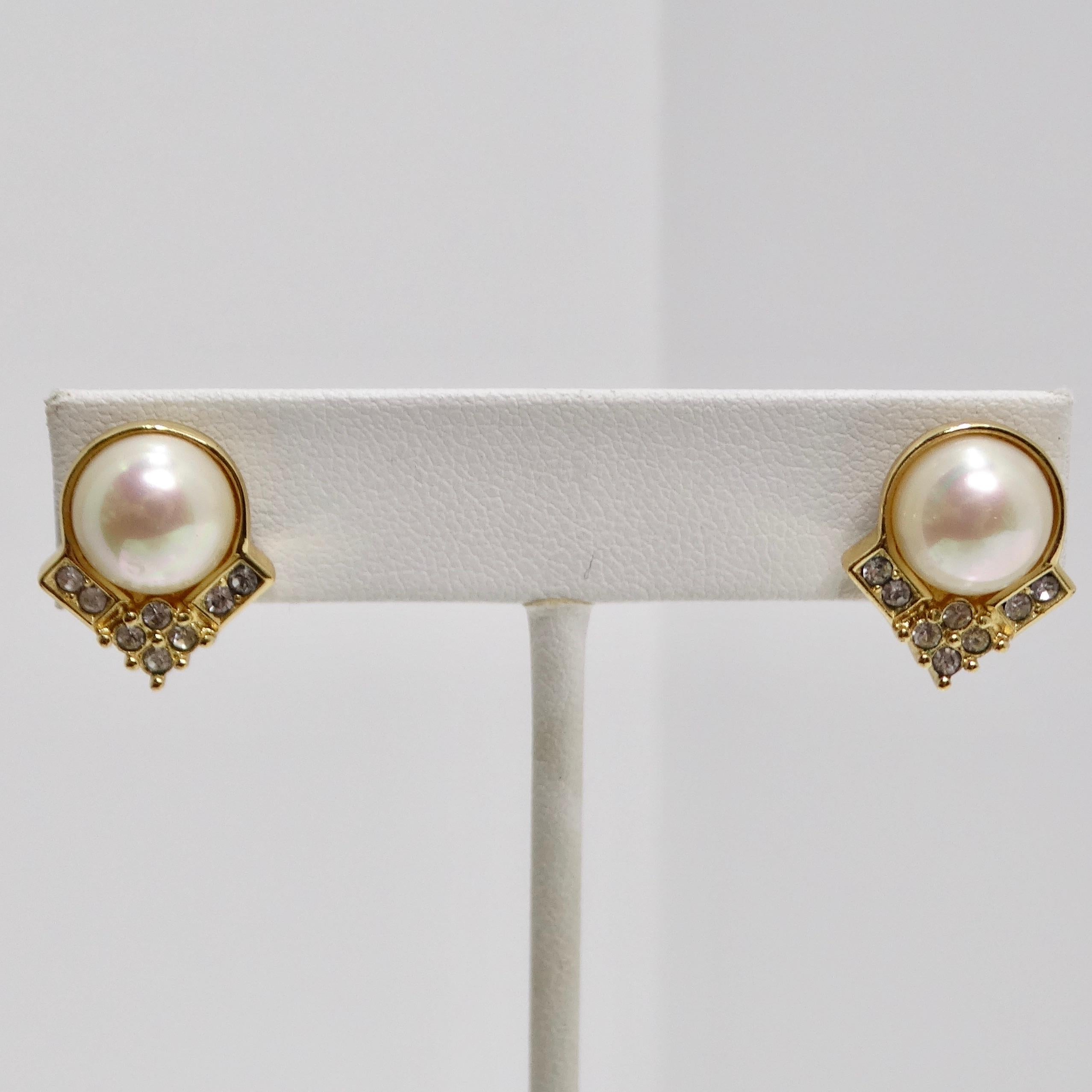 Introducing the 14K Gold Plated Vintage Pearl Earrings, a sophisticated and glamorous pair of stud earrings from the 1990s. These beautiful earrings feature stunning white synthetic pearls, set in 14K yellow gold, which add a touch of elegance and