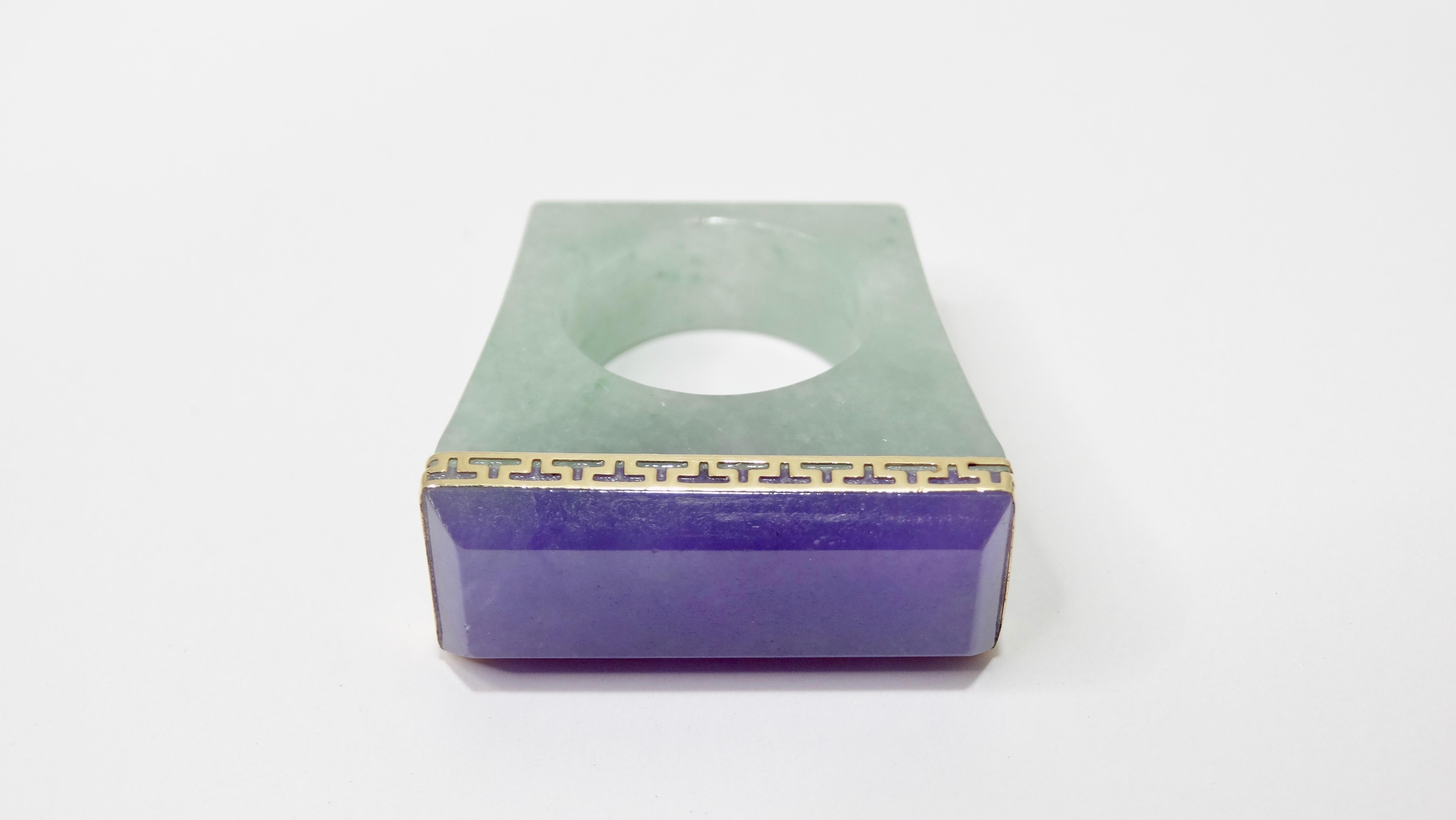 Add this rare Jade treasure to your jewelry collection! Circa 1980s, this stunning ring features a rectangular shape and is crafted from Amethyst and Jade. Framing the baguette cut amethyst is a decorative 14k gold trim. Interior of ring is stamped