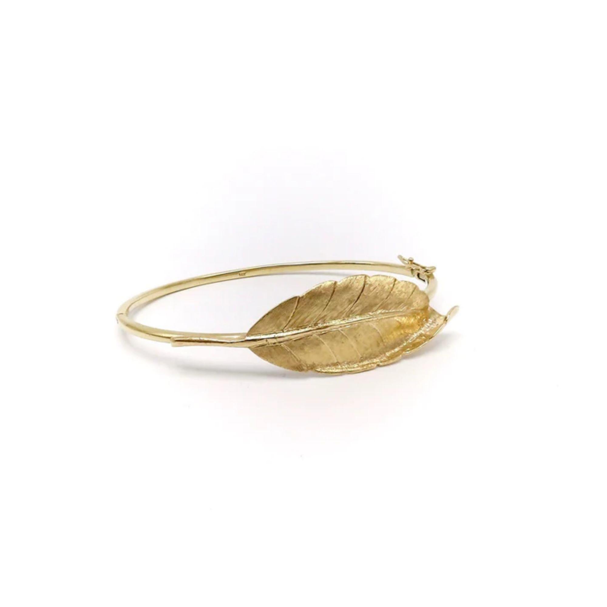 14K Gold Retro Leaf Bangle Bracelet
 
This is a beautiful 14 karat gold leaf bangle from our signature line. The stunning Florentine surface leaf was taken from a Retro brooch. One of the favorite parts of my jobs is reimagining elements of older