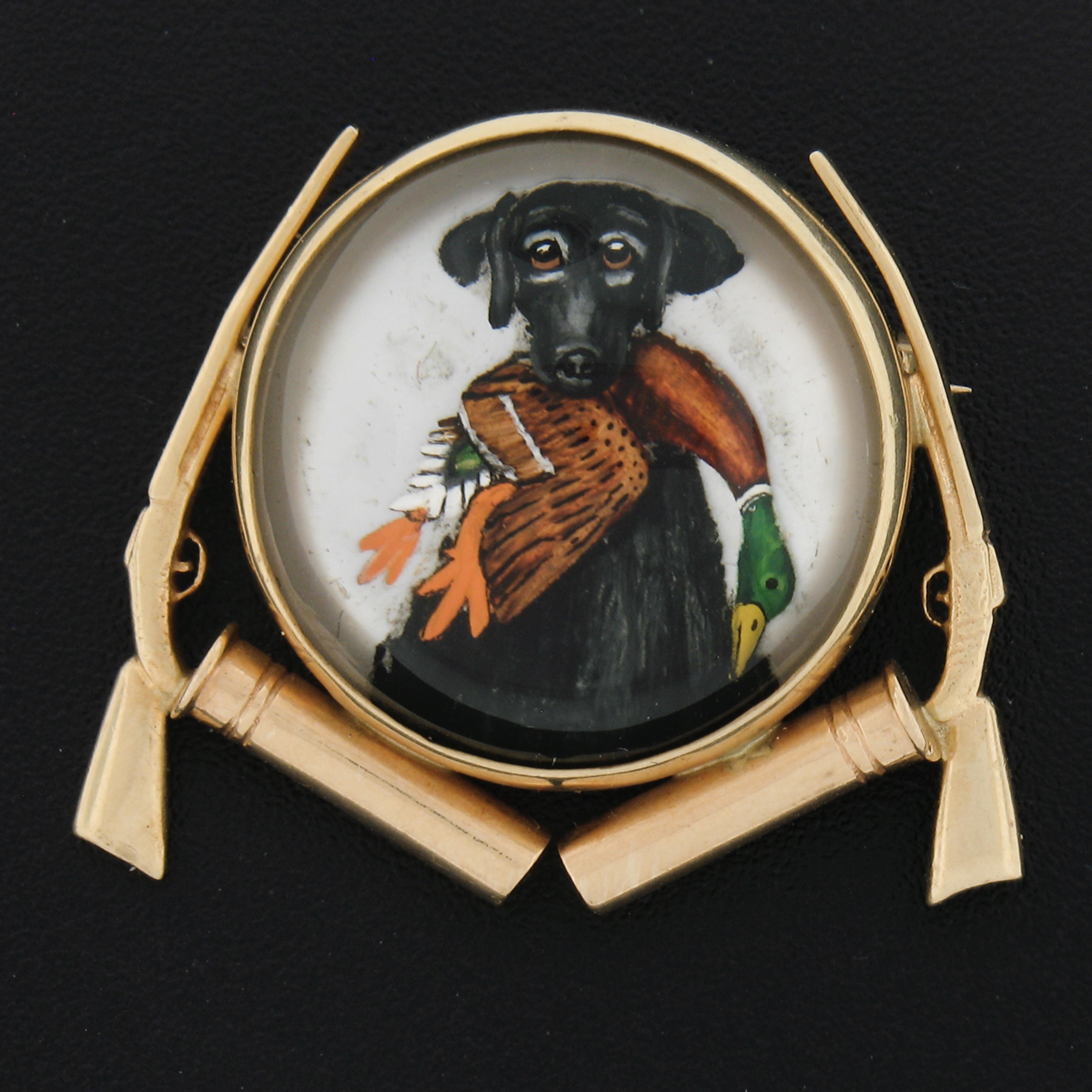 This magnificent vintage brooch was crafted from solid 14k yellow gold. It features an incredibly detailed reverse painted intaglio of a hunting scene with dog holding a duck in mouth. This substnatial brooch displays outstandingly detailed work and