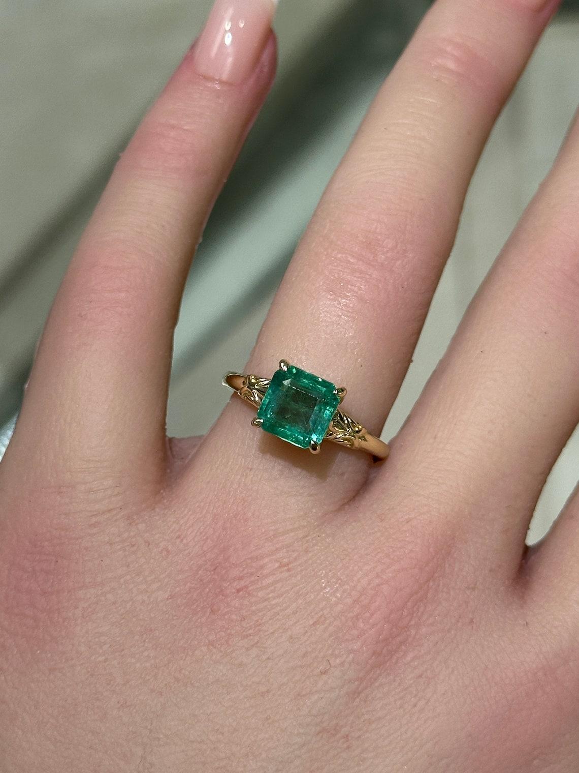 Modern 14K gold ring featuring a 2.37ct natural Asscher cut emerald in a regal floral For Sale