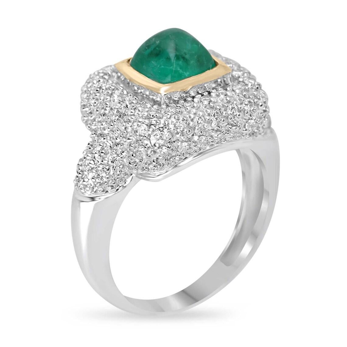 Offrez-vous un glamour inégalé avec notre exquise bague cocktail en émeraude et diamant, ornée en son centre d'une captivante émeraude taillée en pain de sucre, qui attire l'attention par son allure unique. Des grappes de diamants brillants forment