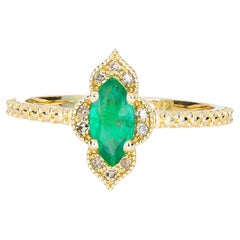 14 Karat Goldring mit Smaragd im Marquise-Schliff und Diamanten