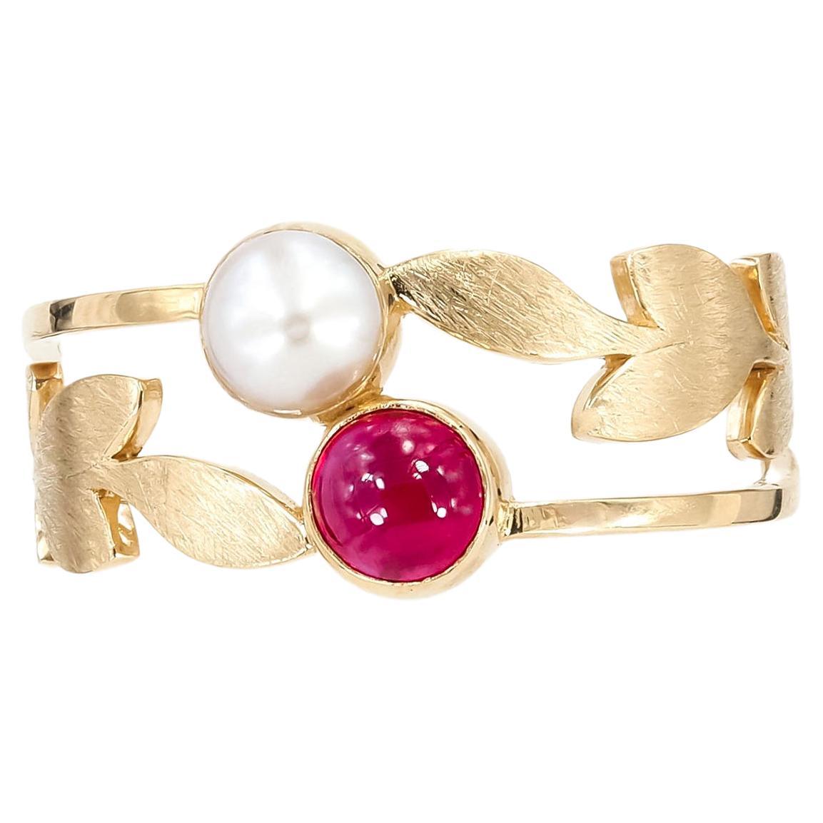 14k gold ring with ruby and pearl

total weight 2.35 gr

Gemstones (all are tested by proffesional gemmologist)

Ruby
round  cabochon cut, 0.5 ct, transparent, red color. 

Freshwater cultivated pearls - 5 mm., white color, button form