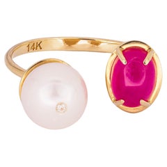 Oval cabochon ruby ring in 14 karat gold. Ruby and pearl ring