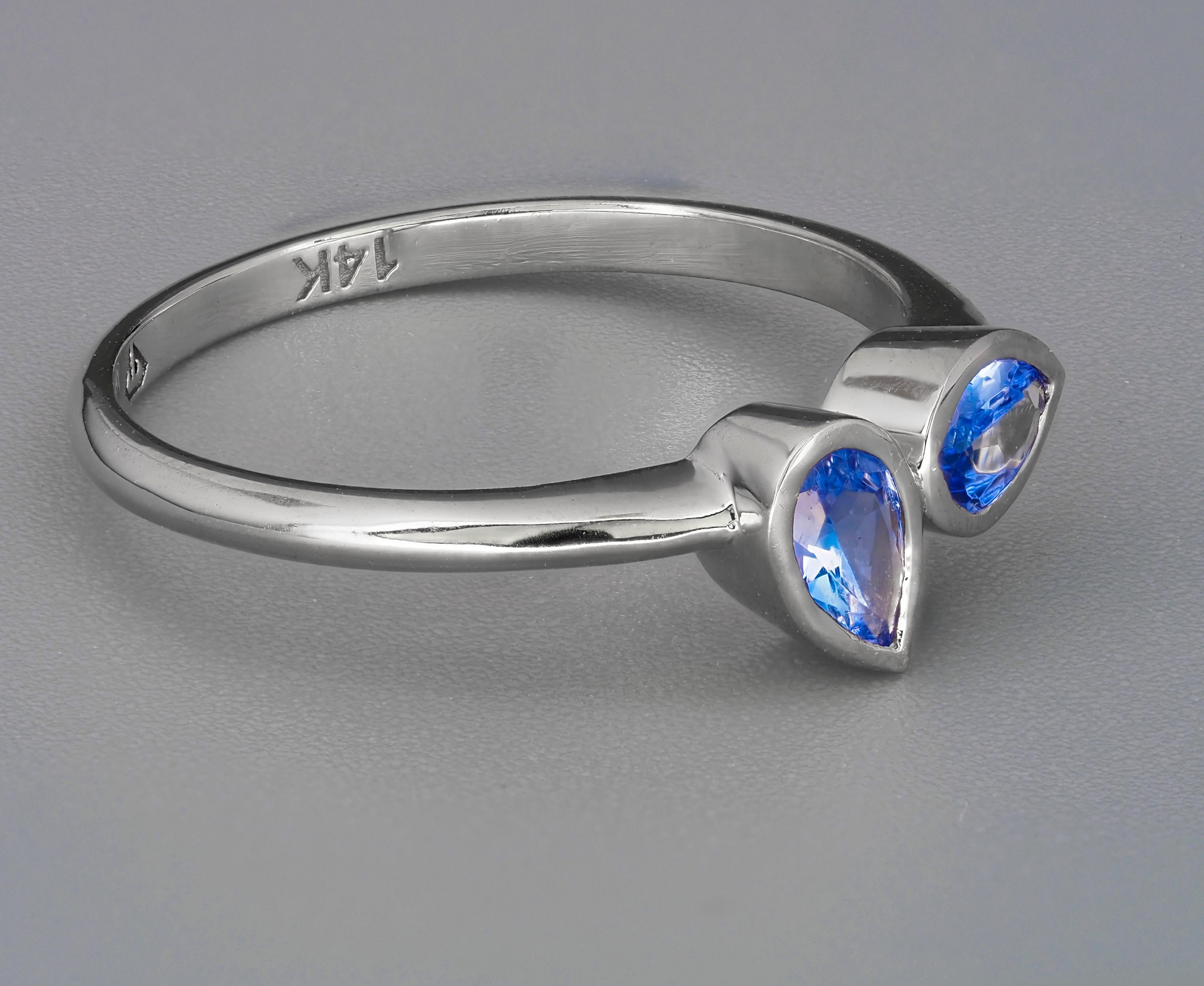 14 k solid gold ring with natural tanzanites. December birthstone.
Weight: 1.85 g.

Central stones: 2 pieces natural tanzanites
Cut: Pears
Weight: approx 0.95 ct. (5 x 4 mm each stone)
Color: Light blue
Clarity: Transparent with inclusions.

auct