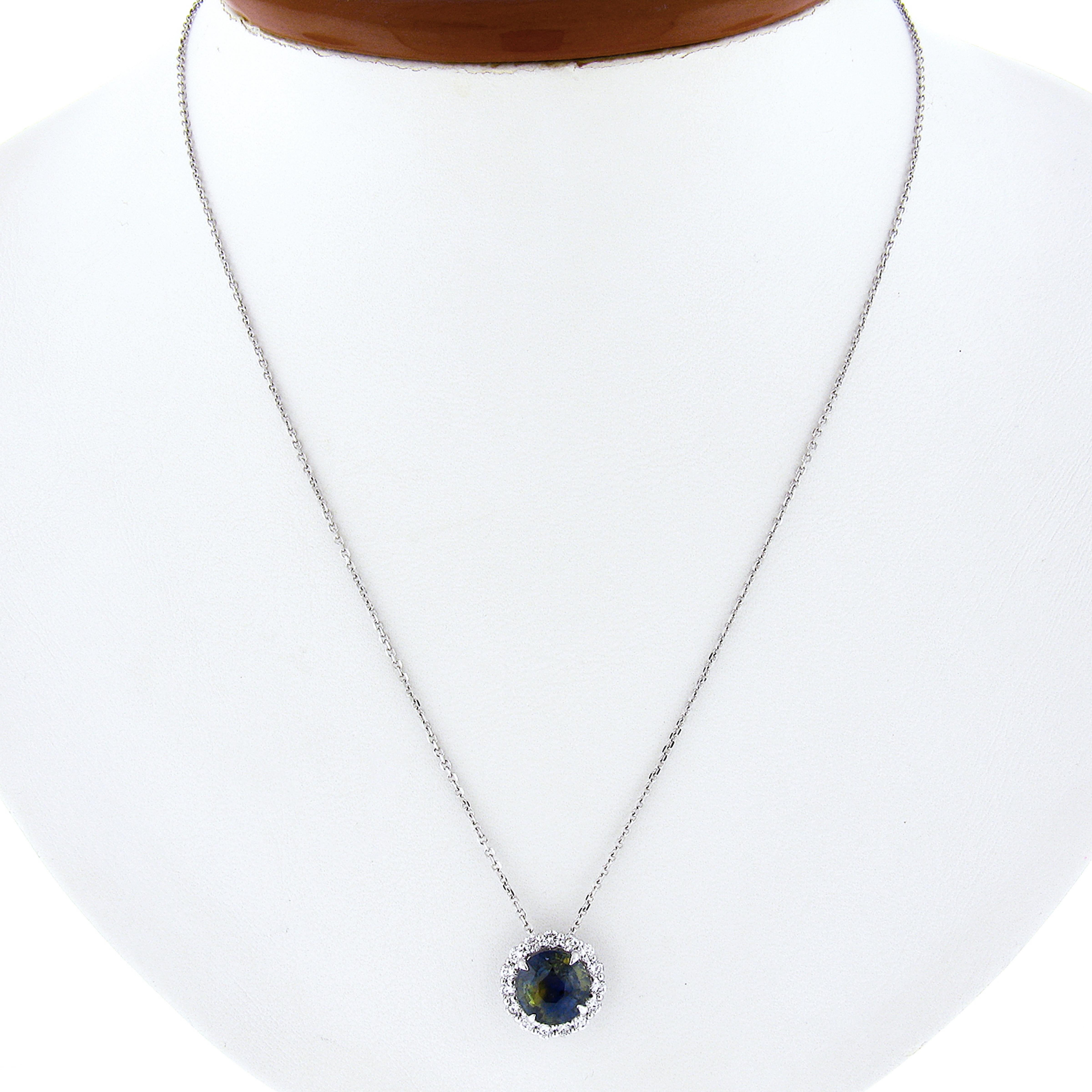 Here we have a gorgeous, brand new, solitaire pendant that is crafted in solid 14k white gold. It features a very unique and truly eye catching, GIA certified, round brilliant cut sapphire with naturally zoned blue and yellow colors. This fine