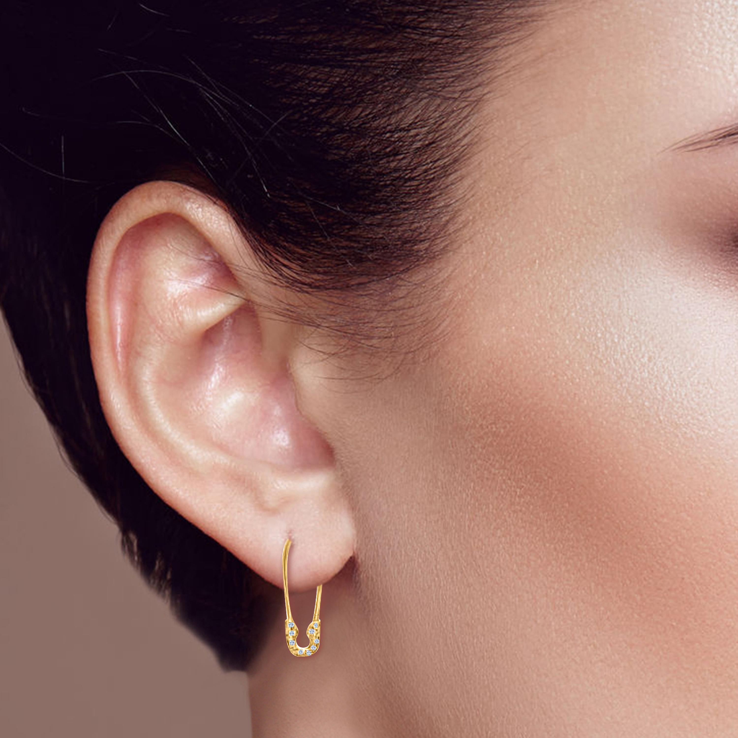 Crafted to captivate, these 14k gold safety pin earrings blend contemporary design with timeless elegance. Adorned with radiant natural diamonds, they exude a subtle brilliance that enhances any ensemble. Offered in rose, yellow, and white gold,