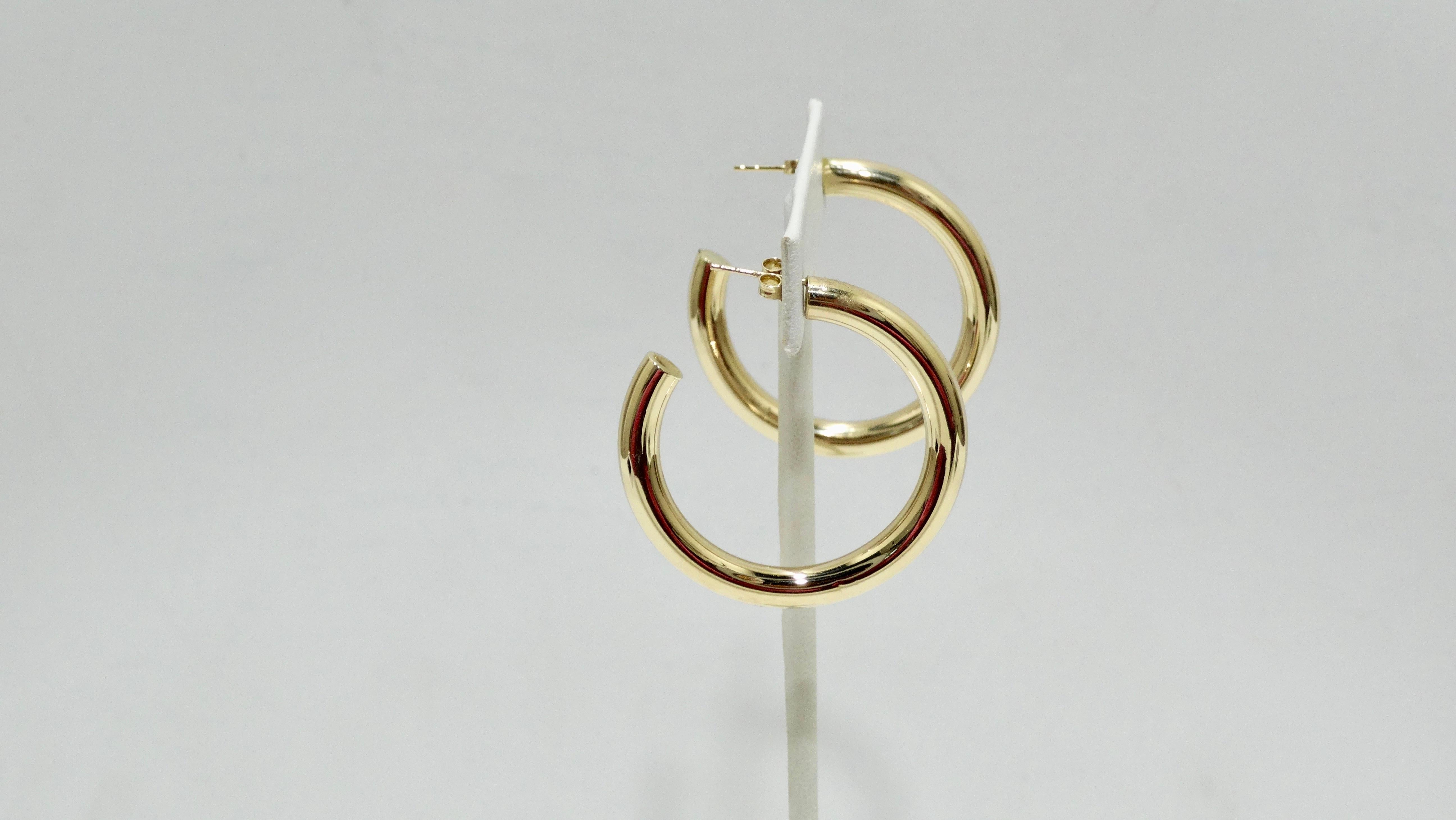 The perfect go-to earrings for your collection! Crafted from 14k gold, these thick banded gold hoops have pierced backs and are stamped 14k gold made in Turkey. Comes with original box and dust bag. Perfect to pair with all your Gucci, Chanel, and