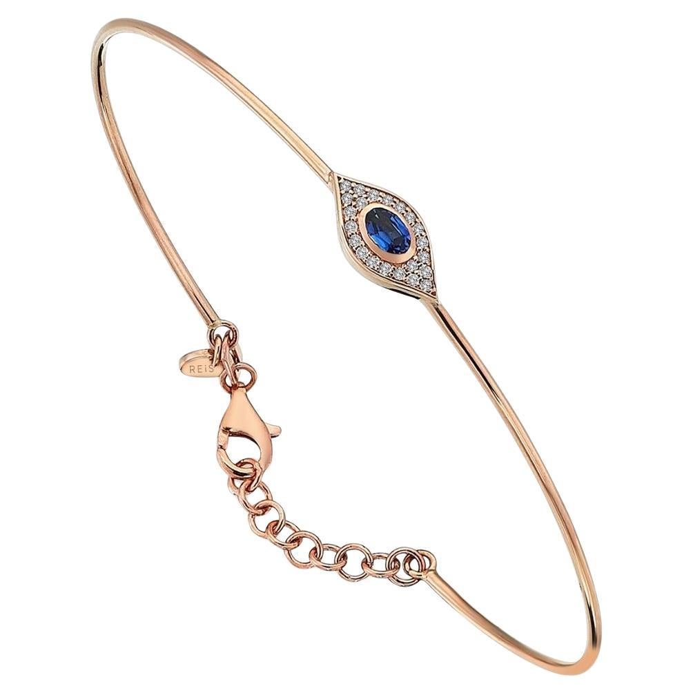 This stunning 14k yellow gold bangle  pavé diamonds, and middle stone with blue sapphire. Featuring one eye motif in the middle. it has an adjustable closure for a secure fit. Mix and match with other bangles for a trendy look. 
 Diamond 0.13 carat
