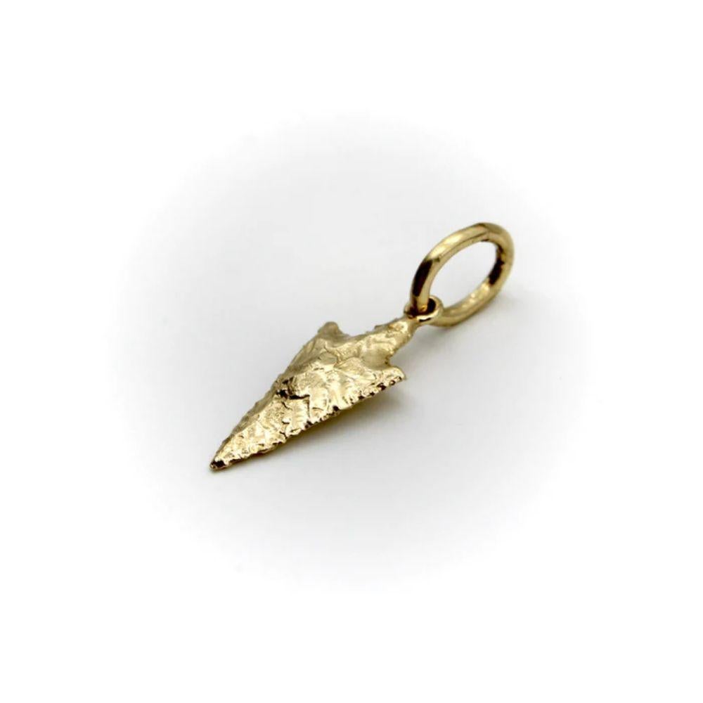 Part of Kirsten’s Corner Signature Collection, this 14k gold arrowhead charm was cast from a mold created using an actual arrowhead. We loved the way the original arrowhead presented itself in gold—the facets of hard rock created beautiful patterns