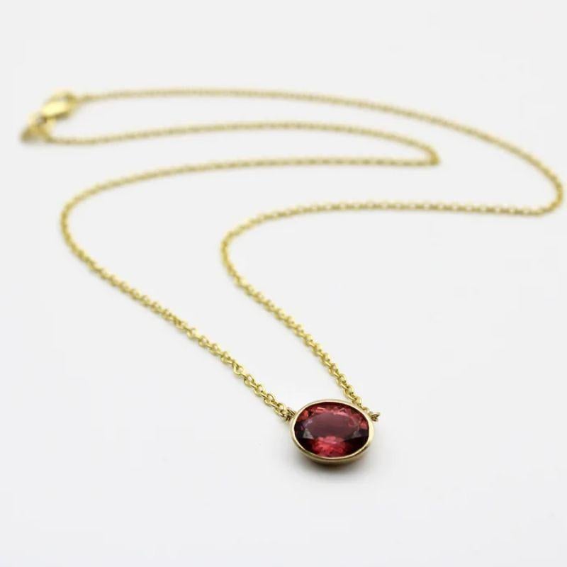 A dusty pink bezel set tourmaline creates the perfect palate for a simple necklace. Suspended in the middle of a 14k gold chain, the tourmaline hangs just above the collarbone. Part of our signature collection, this is a one of a kind piece that