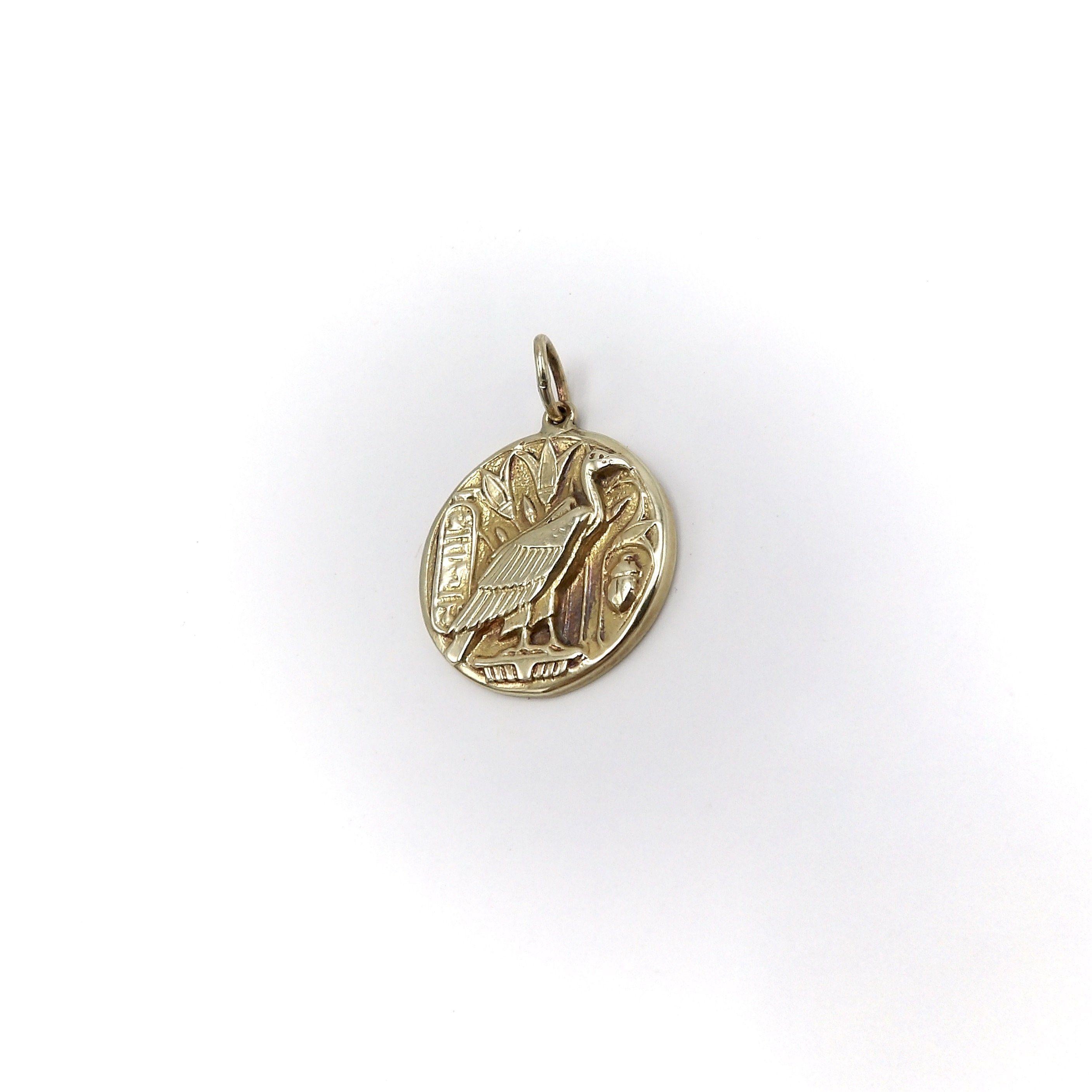 This 14k gold medallion charm is part of the Kirsten’s Corner signature “Cute as a Button” collection. We made a mold from a Victorian-era button and cast them into 14K gold.

It features the Egyptian vulture goddess Nekhbet; the protector of Upper