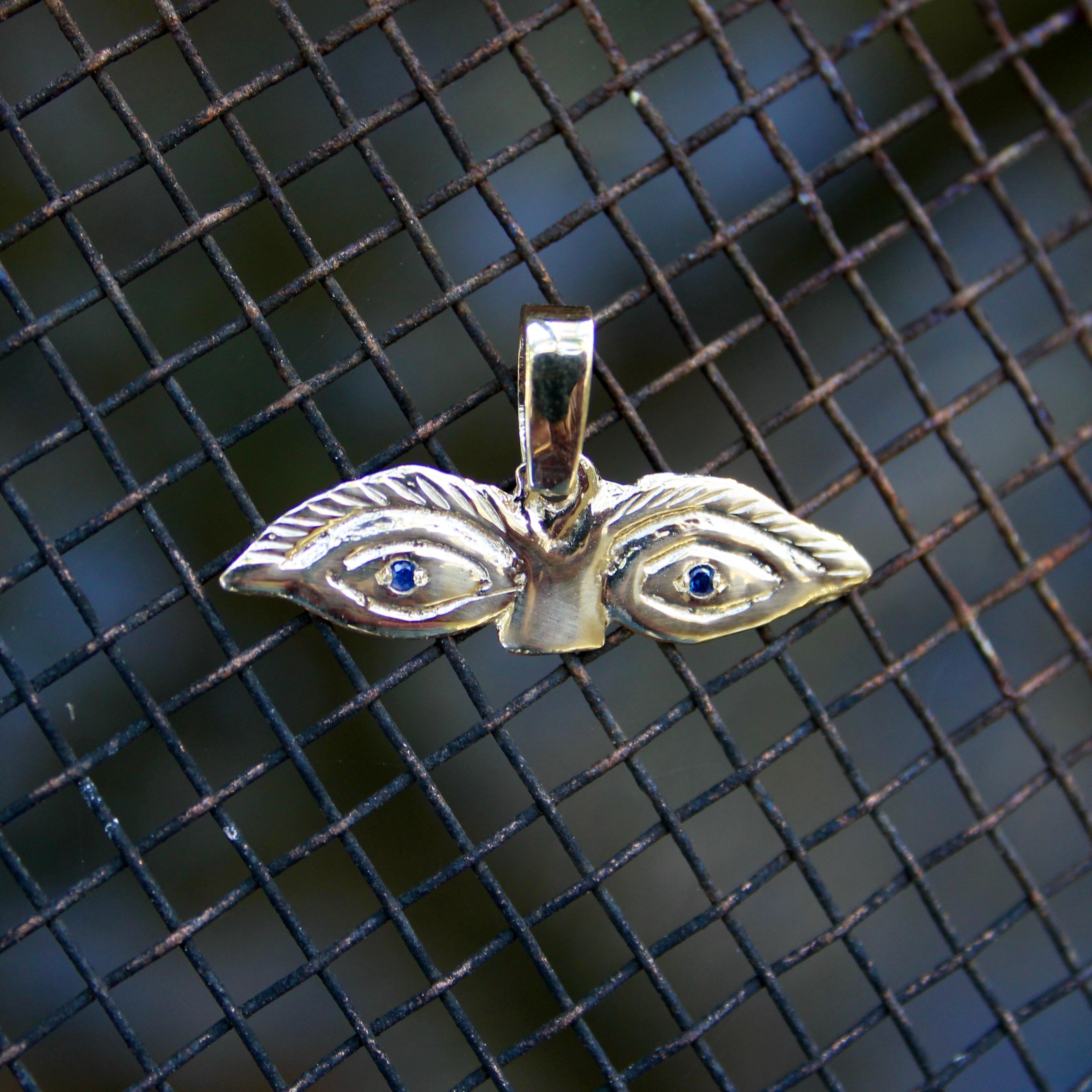 Contemporary 14K Gold Signature Eye Milagro Charm Pendant with Sapphire Eyes For Sale