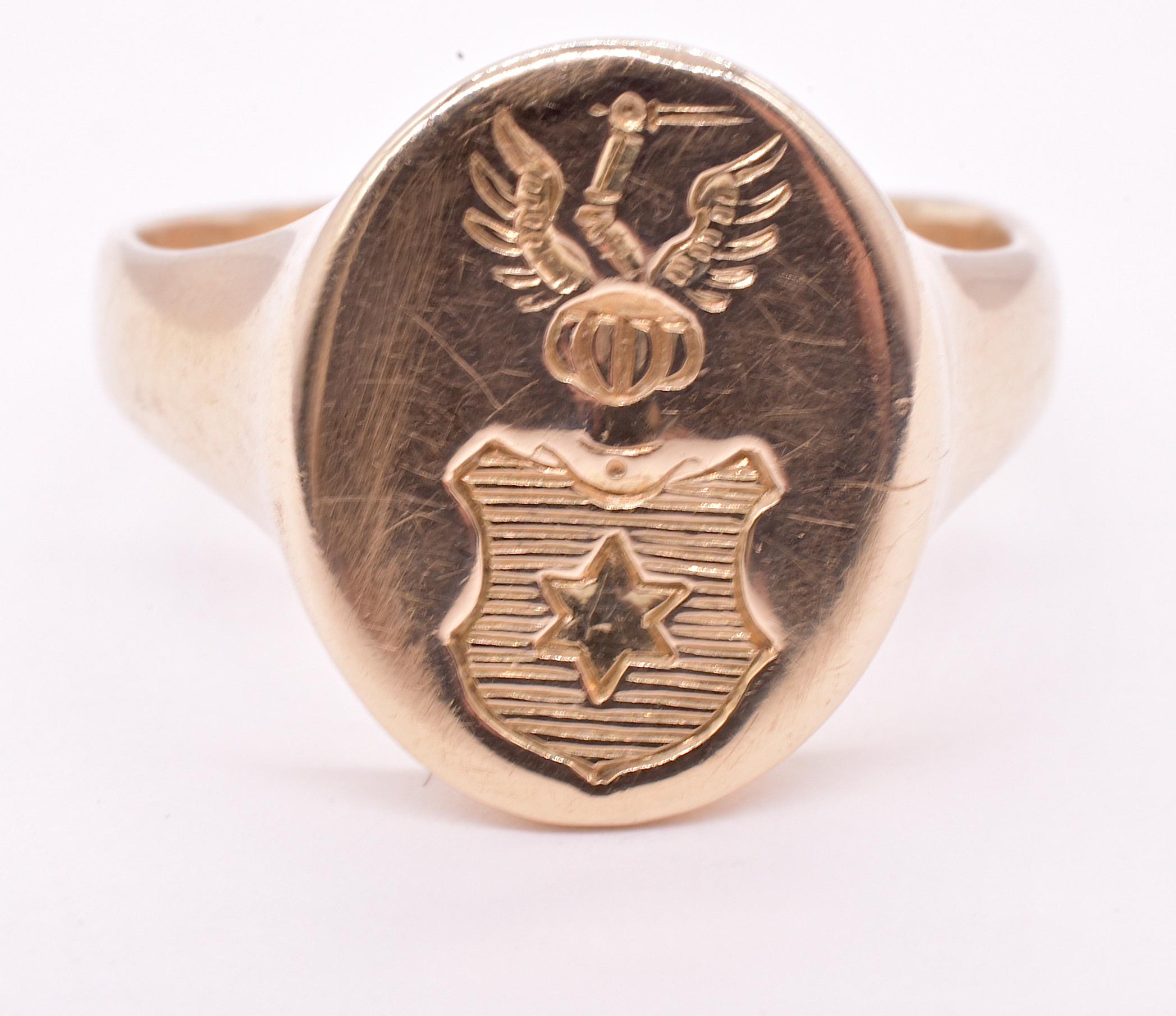 Our 14K signet ring is a stylized representation of a royal coat of arms, depicting a forward facing Royal open visor of gold on an open full faced knight or baron with heraldic details.  The star at the shield's center is a symbol of hope, the
