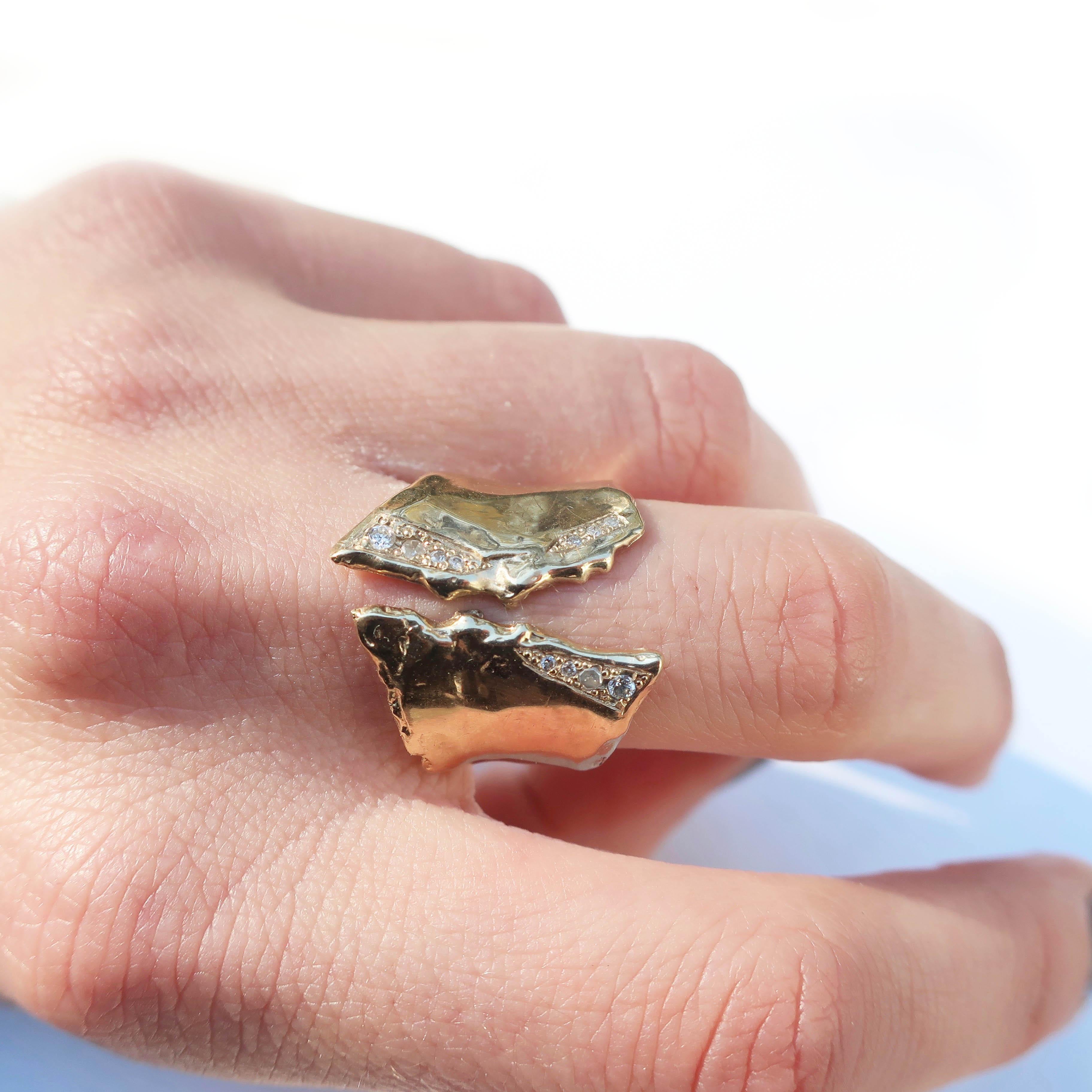 This ring was hand carved and cast in solid 14k gold with pave crushed ice diamonds. A slight concave shape, as well as the split shank style, make for an extremely comfortable and slightly flexible fit. This unisex style tappers to the back for