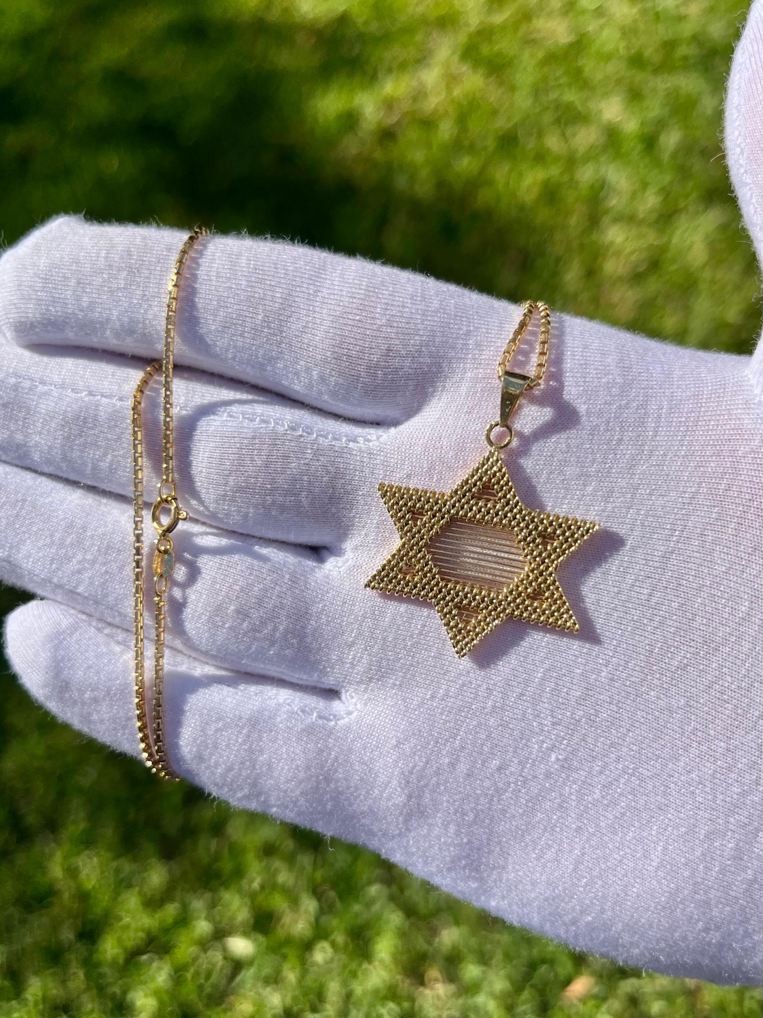 14 karat solid yellow gold Star of David pendant necklace. The pendant has a beautiful textured finish that sparkles under sunlight. Hypoallergenic, double rhodium-plated, and secure ball clip closure. A piece that is ideal for everyday wear. The