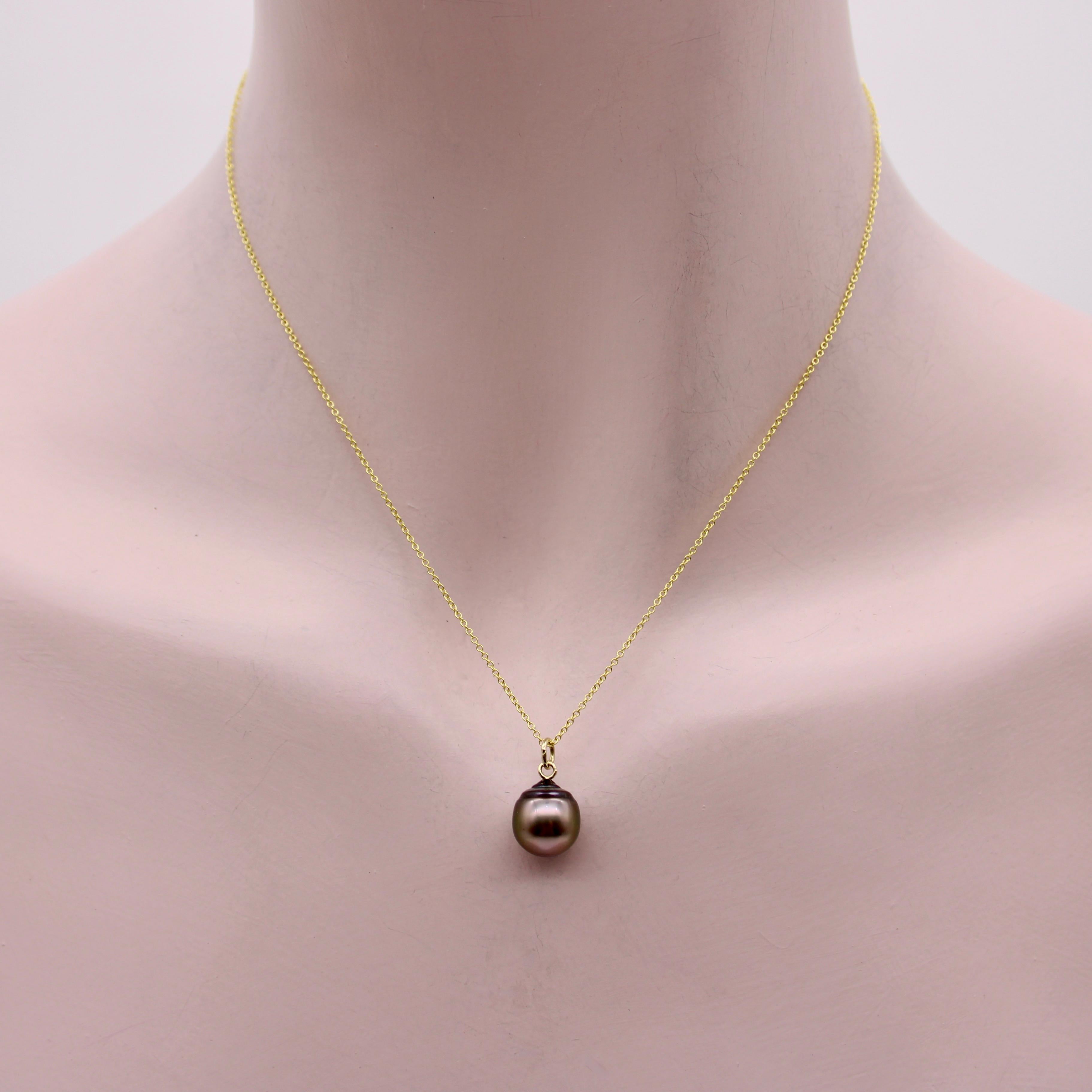 This Tahitian South Sea Black Pearl is beautifully round with a gorgeous, lustrous nacre. It connects at its drop point to a delicate 14k gold chain, making it a simple and stunning pendant necklace. The pearl is elongated at the top and makes for