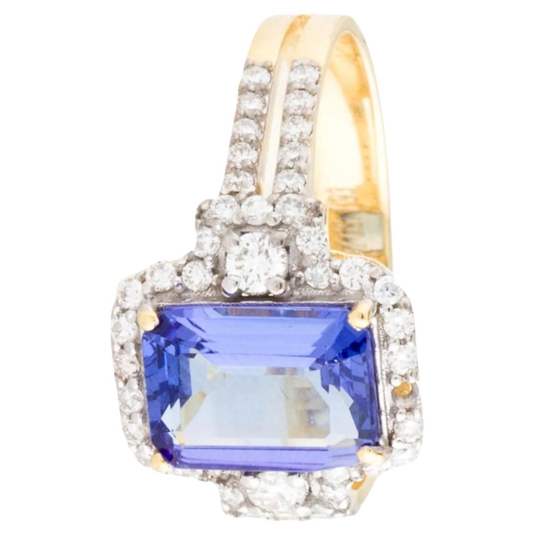 Elevate your ensemble with this exquisite 14K yellow gold cocktail ring, boasting a stunning 1.77 carat emerald cut tanzanite as its centerpiece, exuding a mesmerizing violet hue. Surrounding it are 51 round brilliant diamonds totaling 0.37 carats,