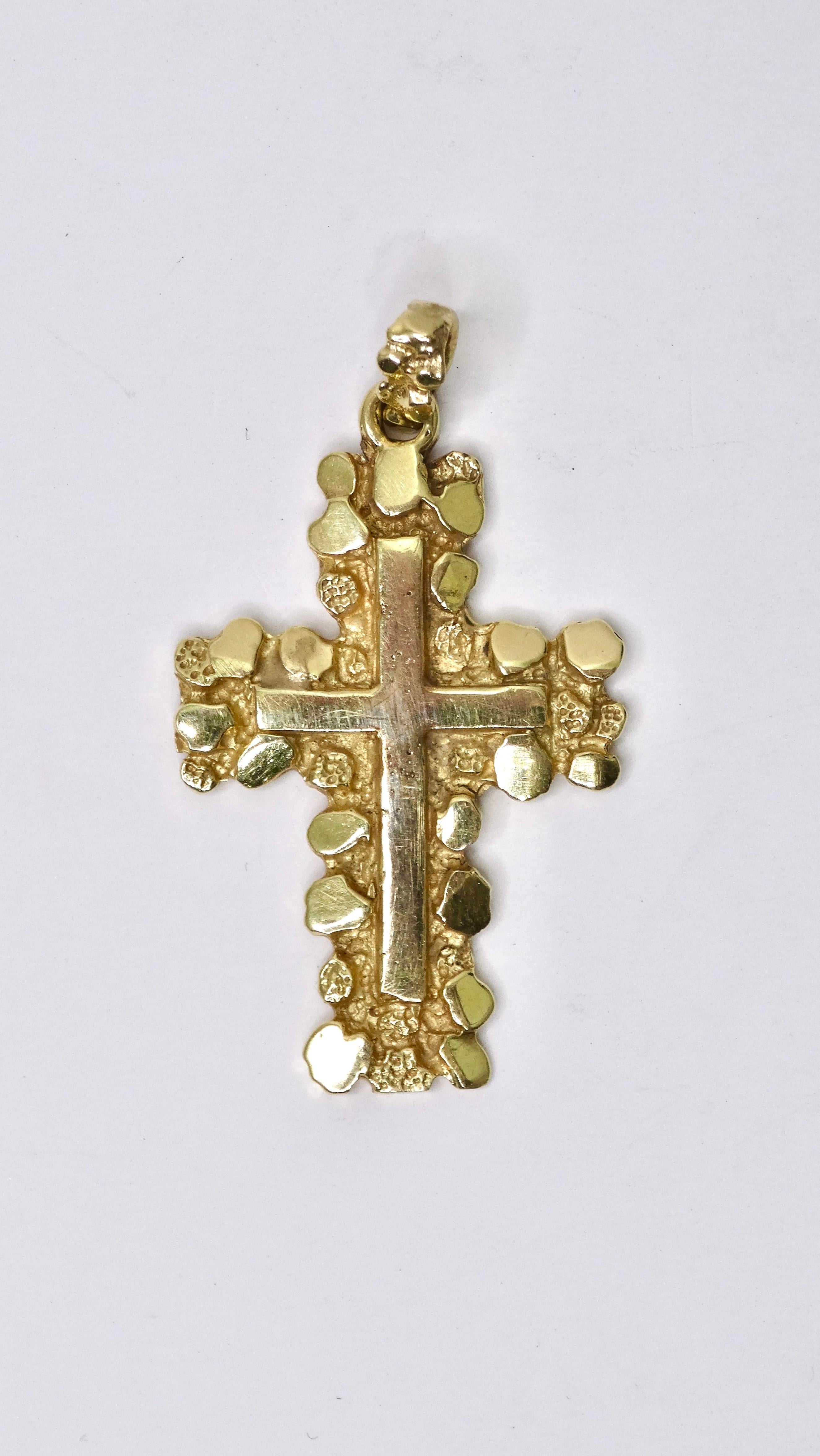 Feel confident and powerful in this 14k gold necklace enhancer! This necklace pendant is incredibly detailed with super detailed engravings that will draw you in. This has an interesting textured and pebbled effect complimented by a smooth cross
