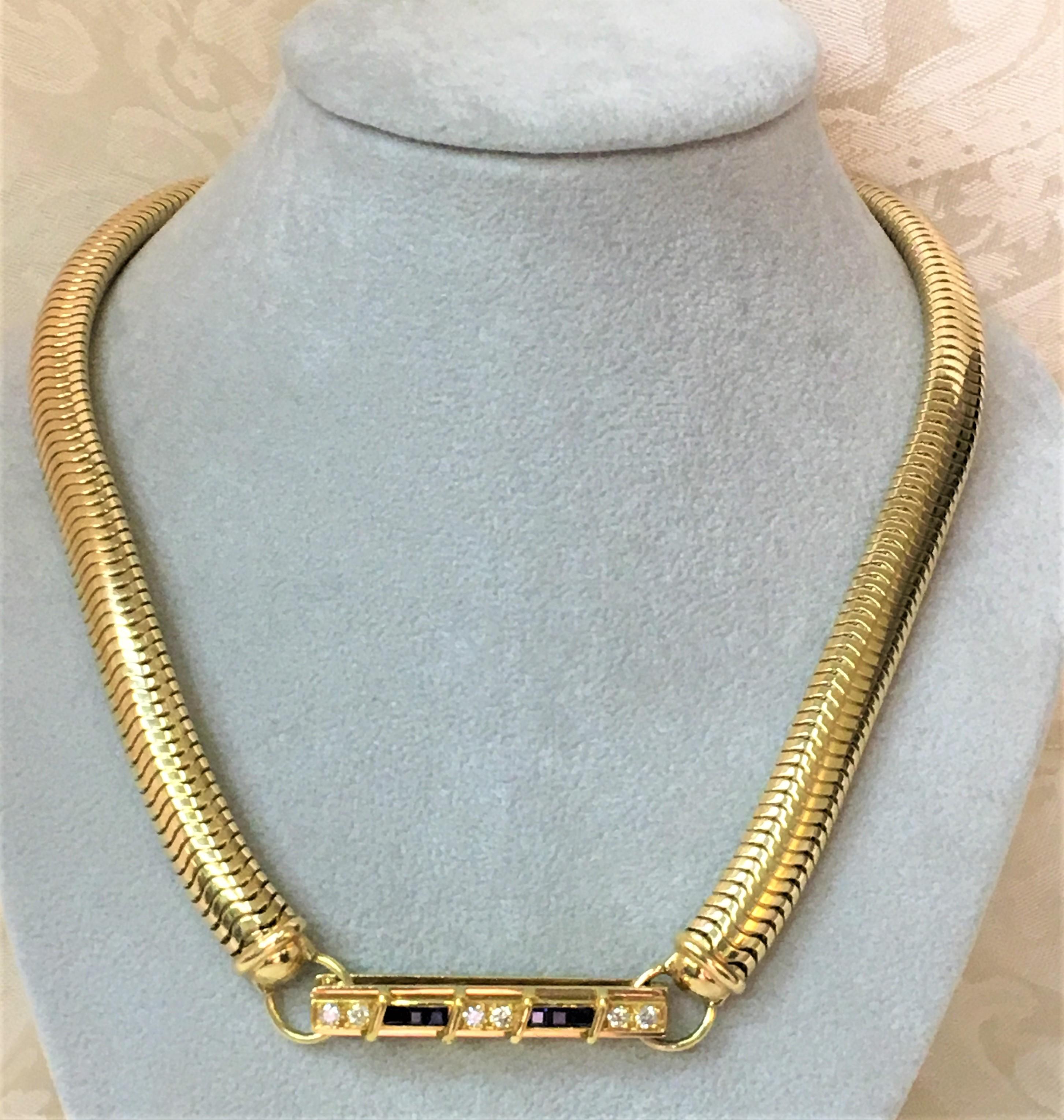 This is truly a one-of-a-kind piece with a beautiful clasp!   
Necklace can be worn with the clasp in front, back or side, giving you several looks with one piece!
14 karat yellow gold snake necklace,  approximately 9mm wide
Gold clasp has 6