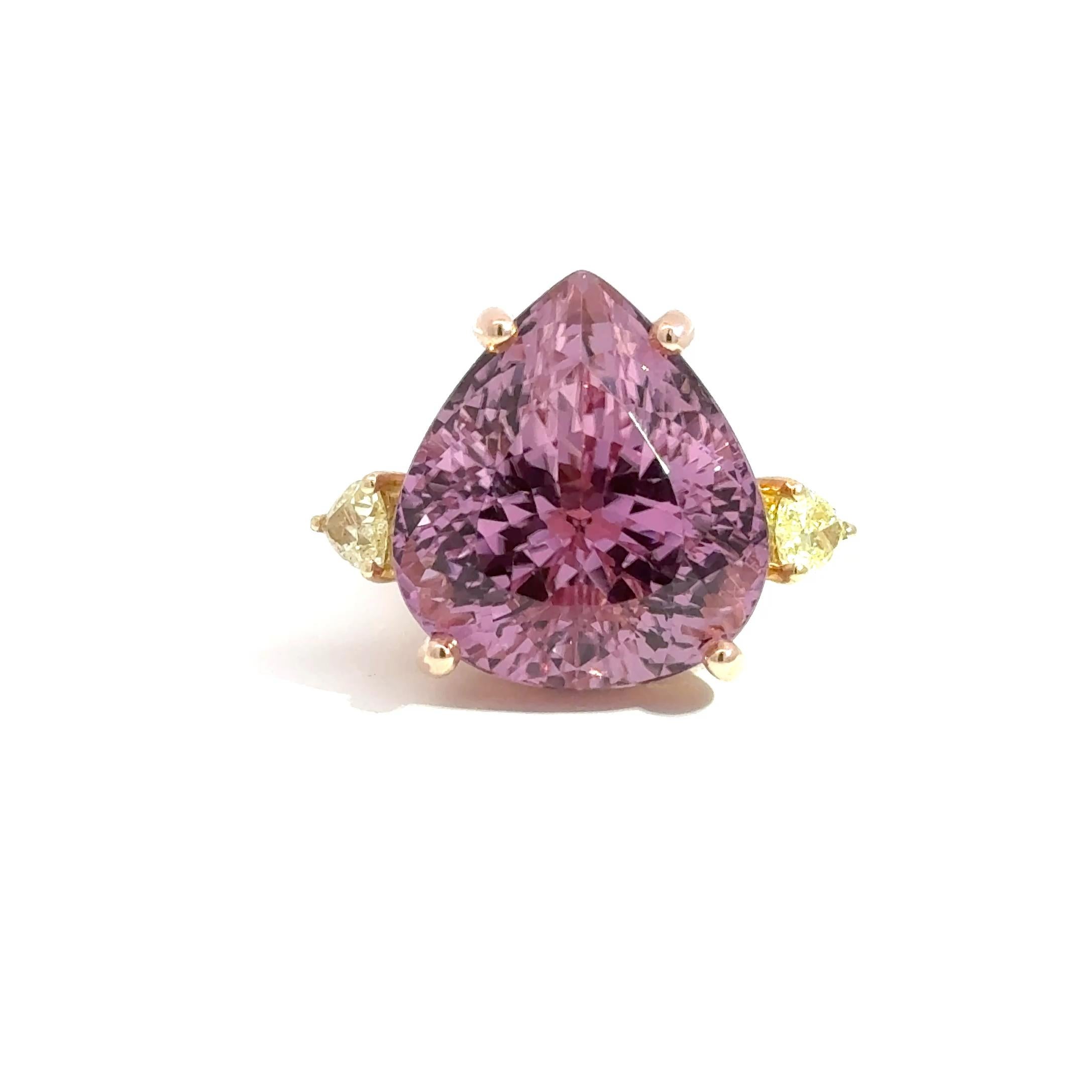 A breathtaking statement piece, this one-of-a-kind cocktail ring features a vivid 38.93-carat pear-shaped kunzite, masterfully set in an ornate combination of 14k rose and yellow gold. The mesmerizing center stone is flanked by two rare fancy yellow