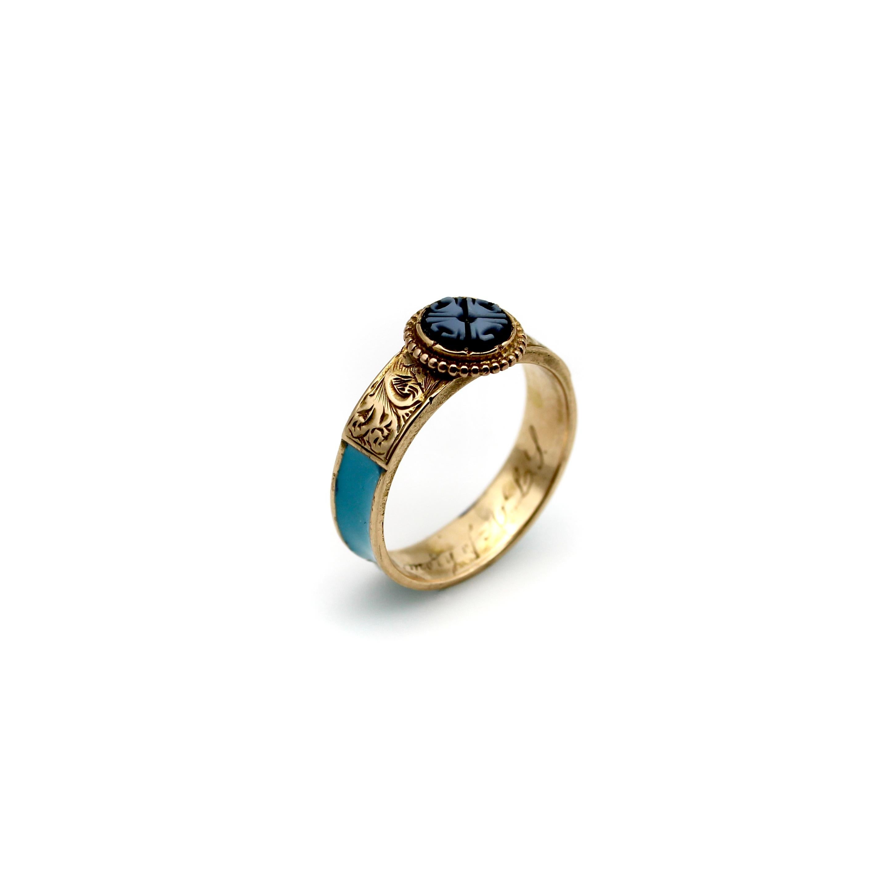 This delicate and dear 14k gold ring combines some of the most enticing qualities of Victorian mourning jewelry. In its center is a banded agate disk carved with a quatrefoil design. The agate contains two shades of blue that create an intricate
